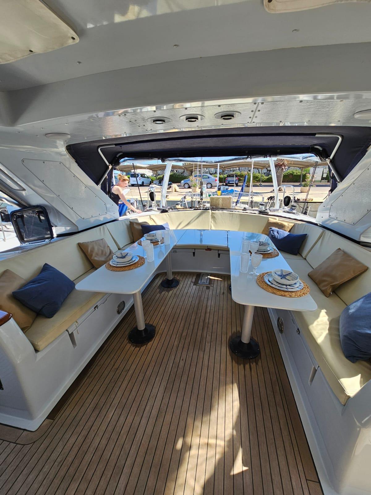 Luxurious interior of 1991 CIM Maxi 88 Cutter Sloop with elegant dining setup.