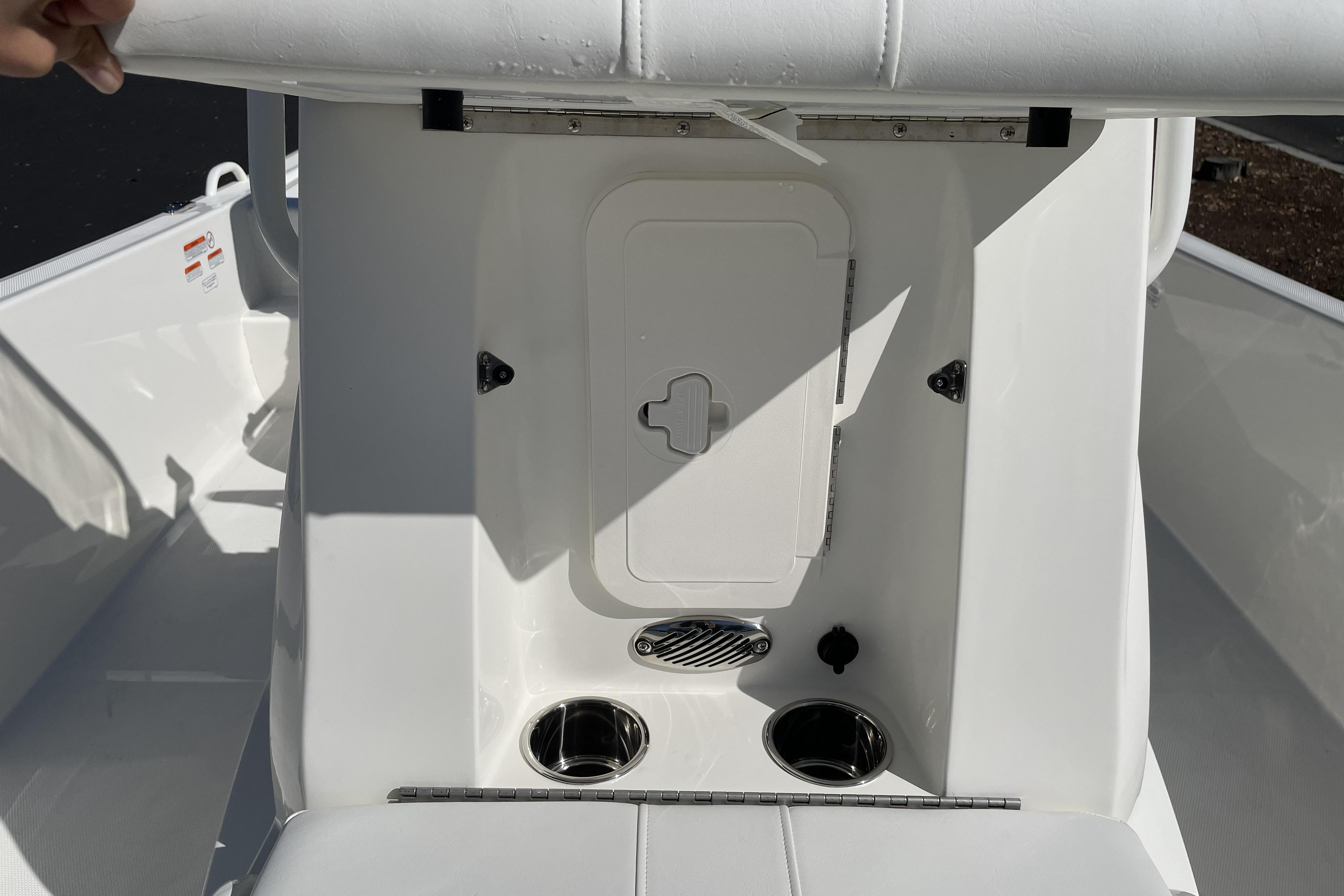 2026 Mako Pro Skiff 19 CC boat interior with storage compartment and cup holders.