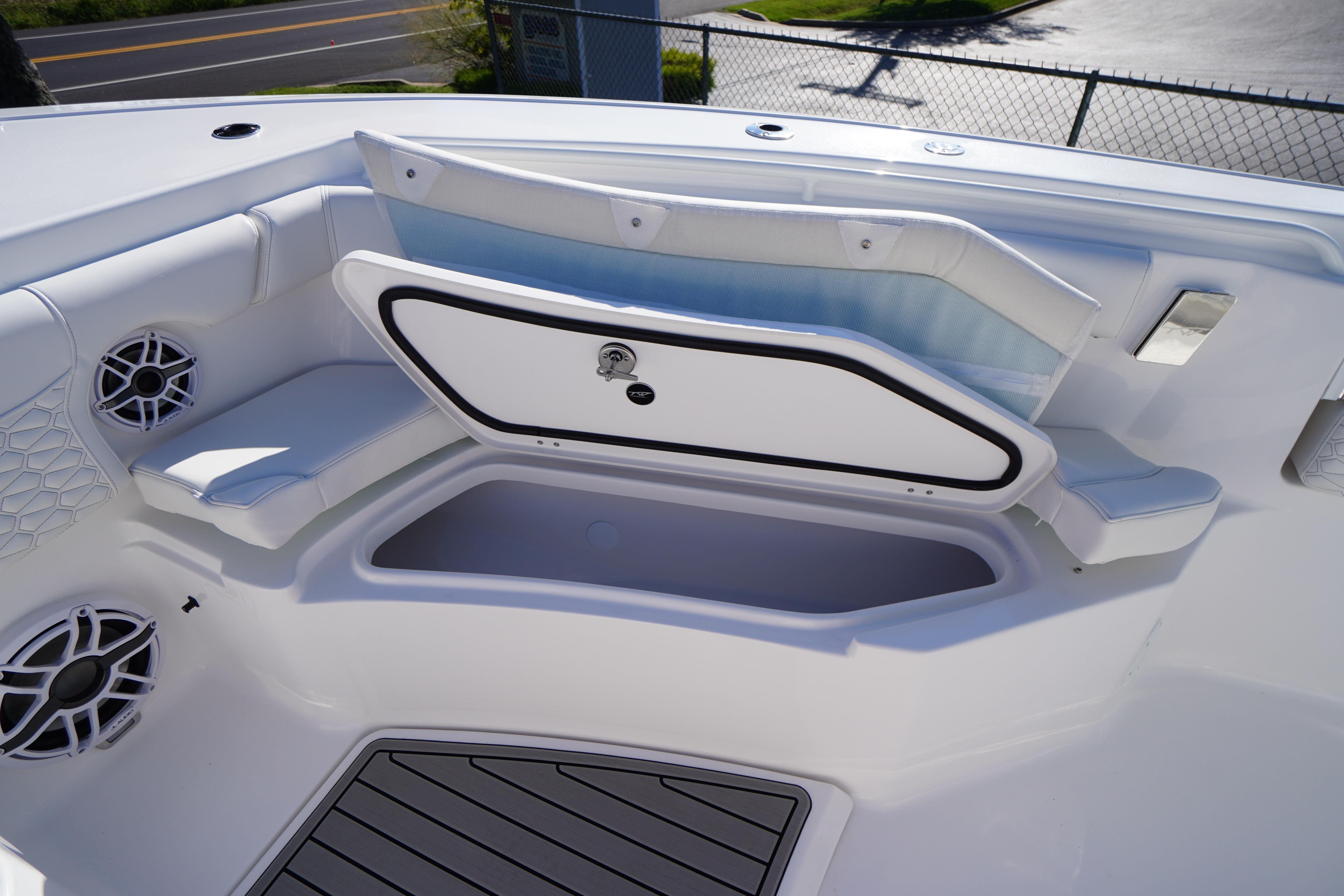 2026 Tidewater 272 LXF boat interior with open storage compartment and seating.
