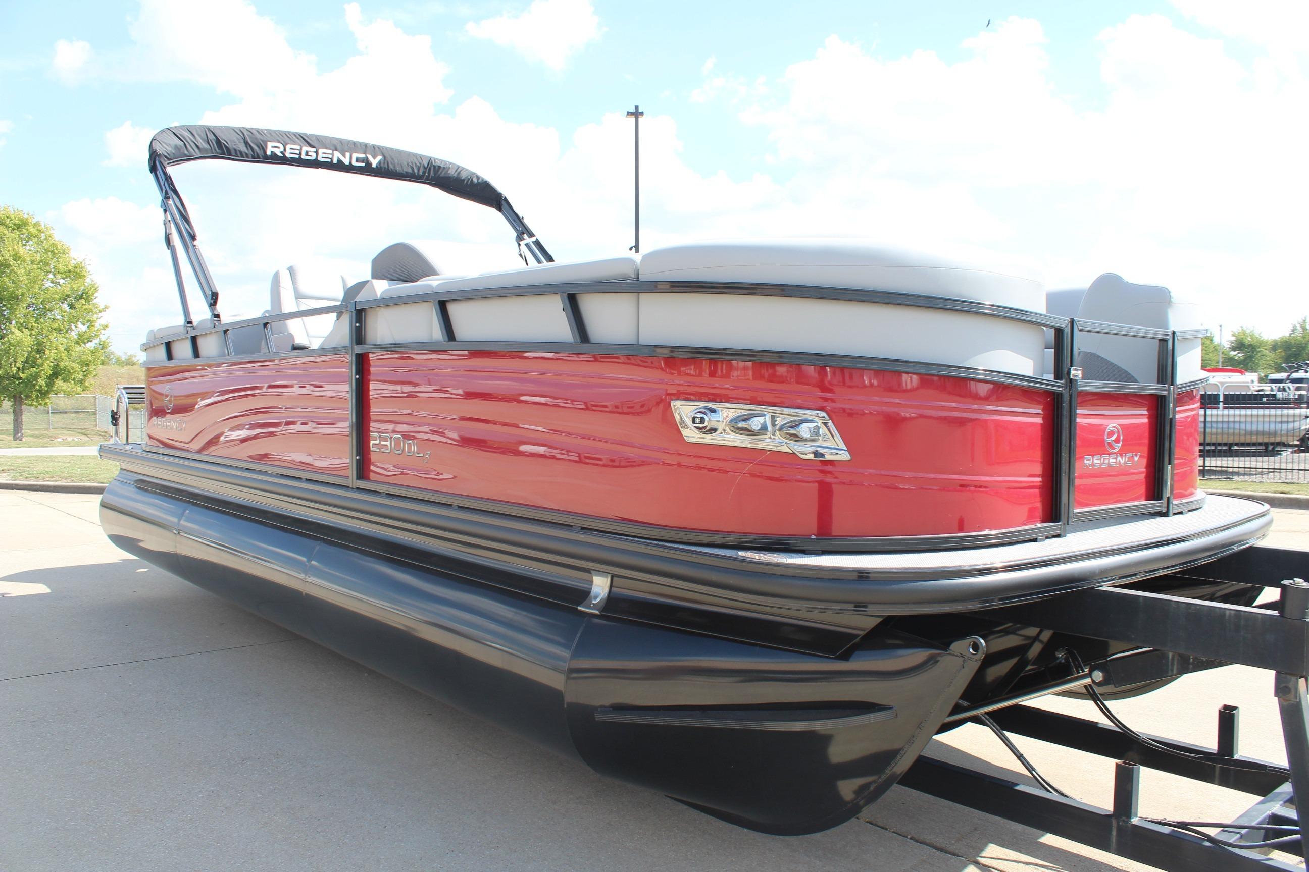 2025 Regency 230 DL3 pontoon boat with red exterior and black trim on a trailer.