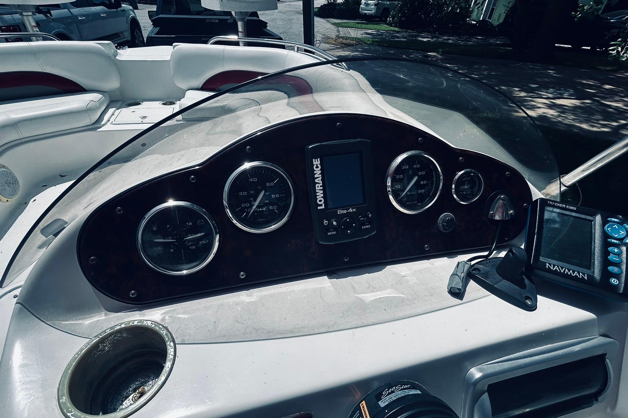 Dashboard of a 2013 Hurricane SunDeck Sport 201 OB boat with navigation instruments.
