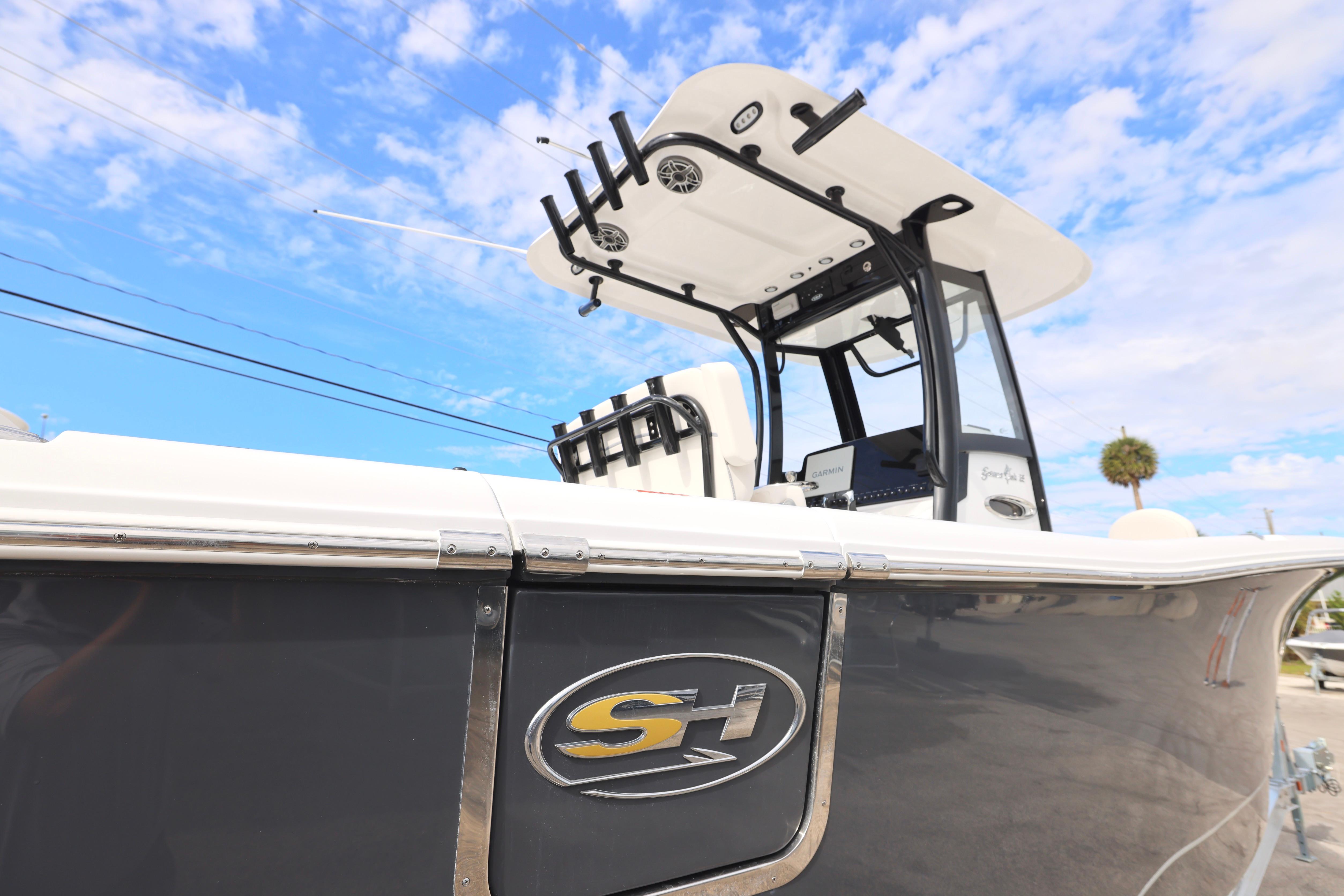 2026 Sea Hunt Gamefish 25 boat with sleek design under a blue sky.