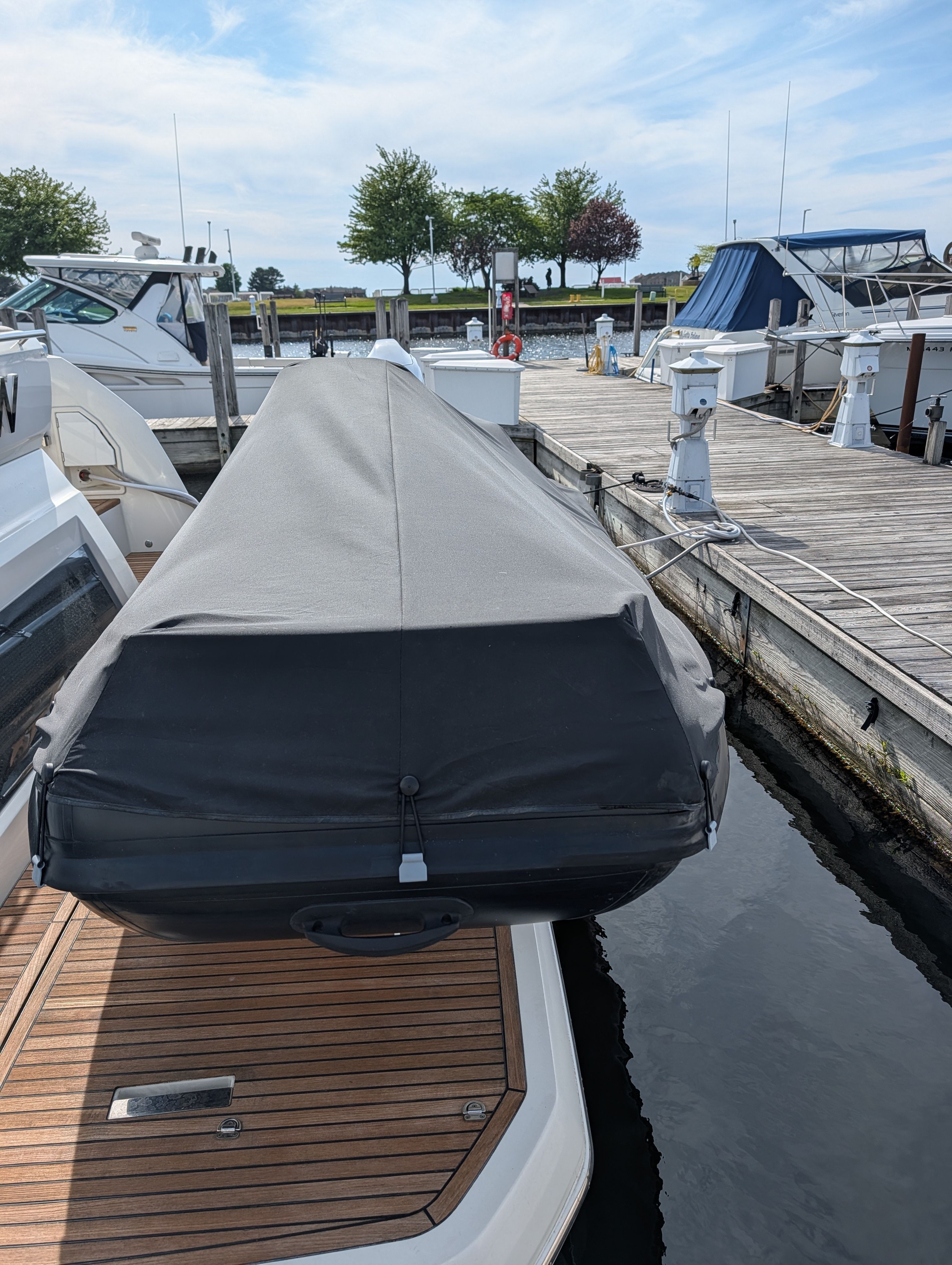 2024 Highfield Sport 390 boat with cover at the dock.