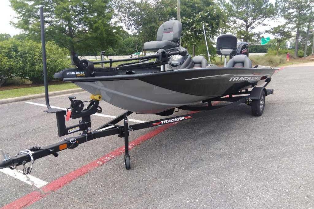 2026 Tracker Pro Team 190 boat on trailer in parking lot, featuring Minn Kota motor.