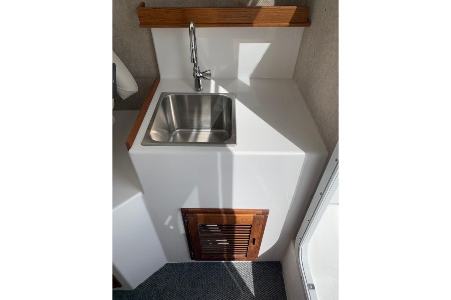 Compact sink area in 2026 Sea Sport Kenai 2600 boat interior.