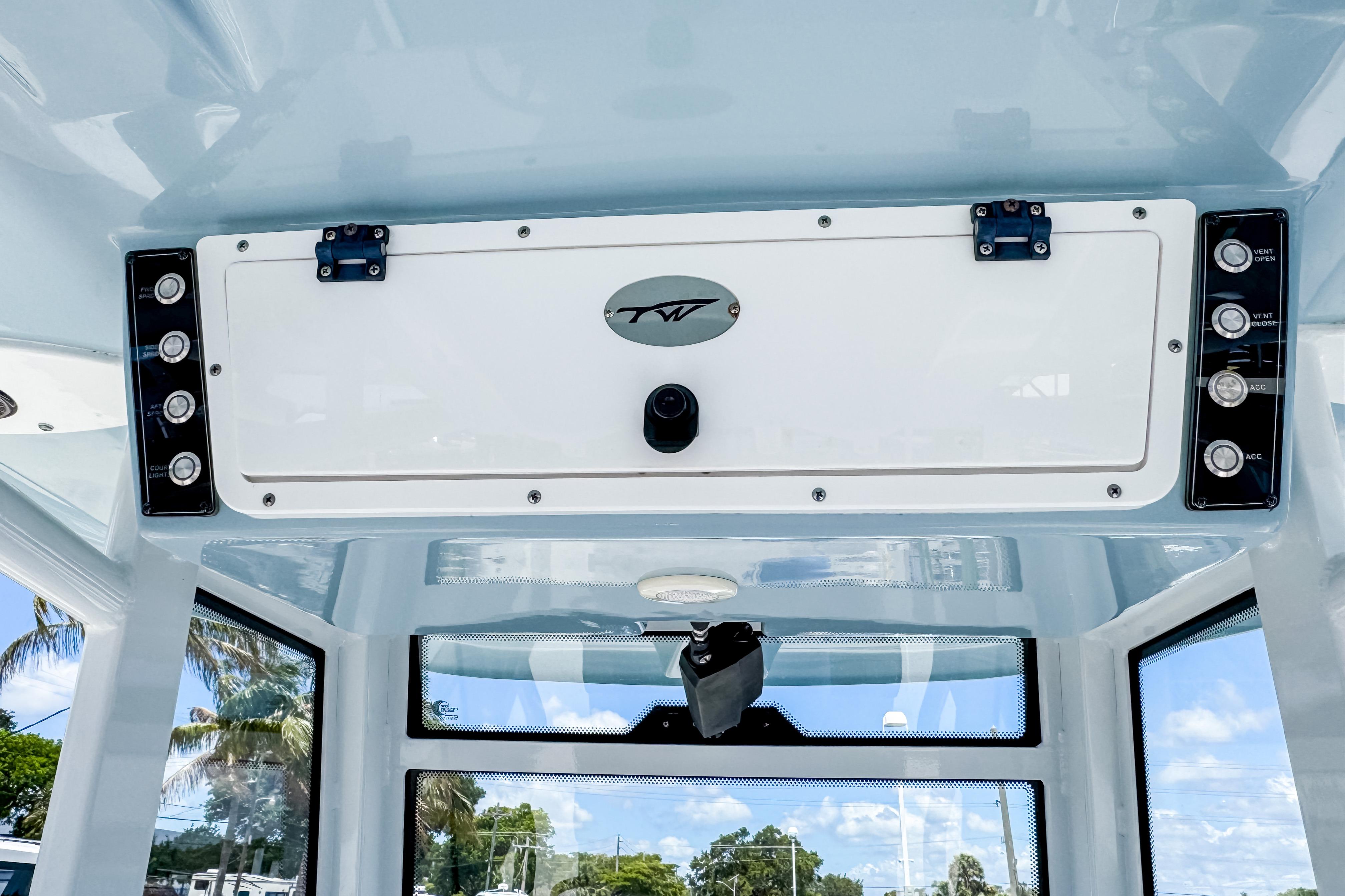 2023 Tidewater 280 CC Adventure boat console with control panel and storage compartment.
