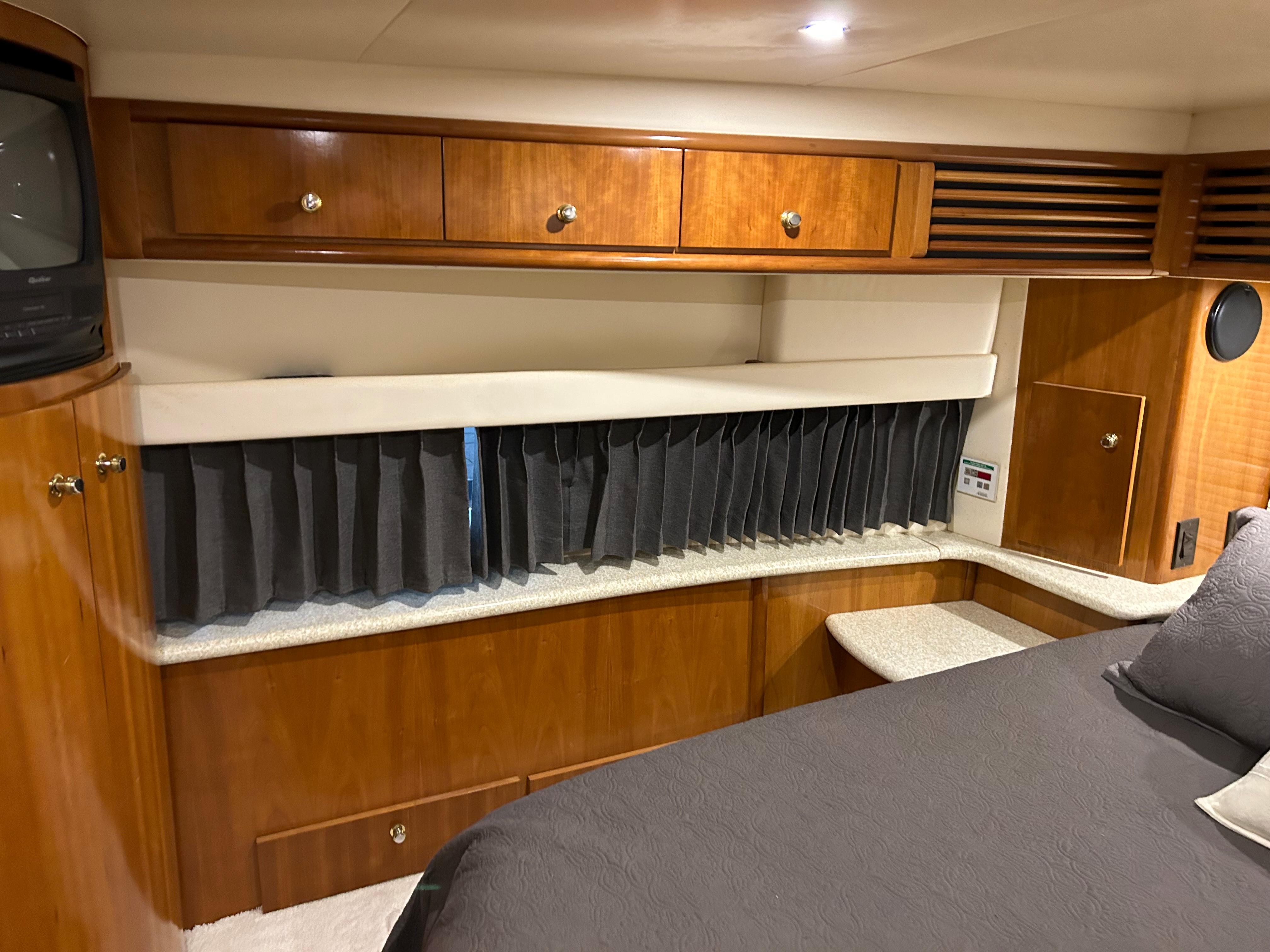 2000 Carver 396 yacht interior with wood cabinetry and cozy sleeping area.