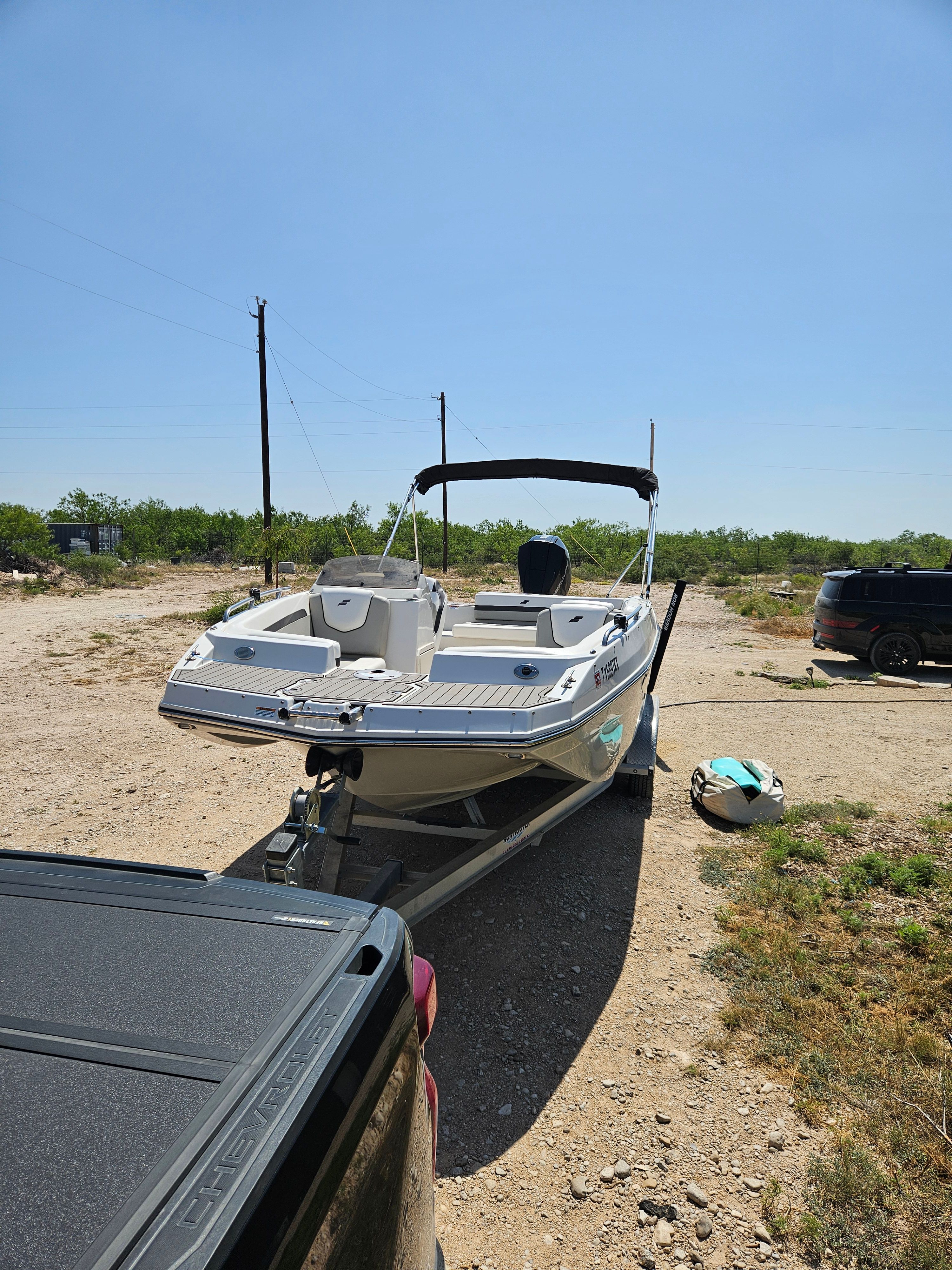 A 2023 Starcraft SVX211 boat on a trailer in a dry, rural setting.