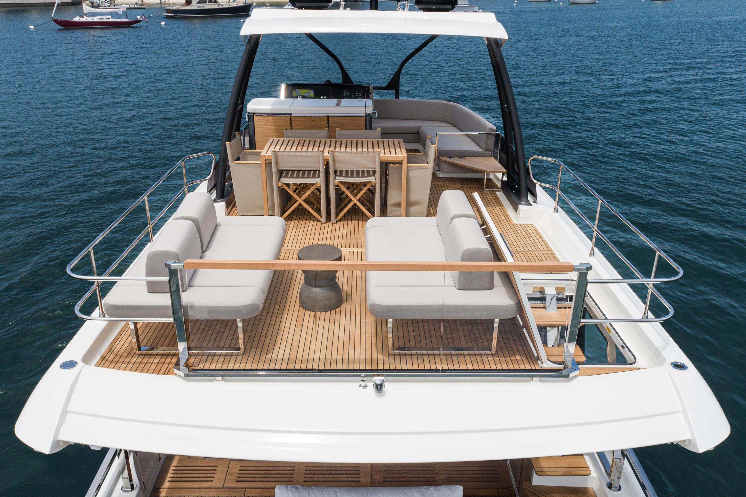 Luxurious 2024 Prestige X60 yacht with elegant deck seating and dining area on the water.