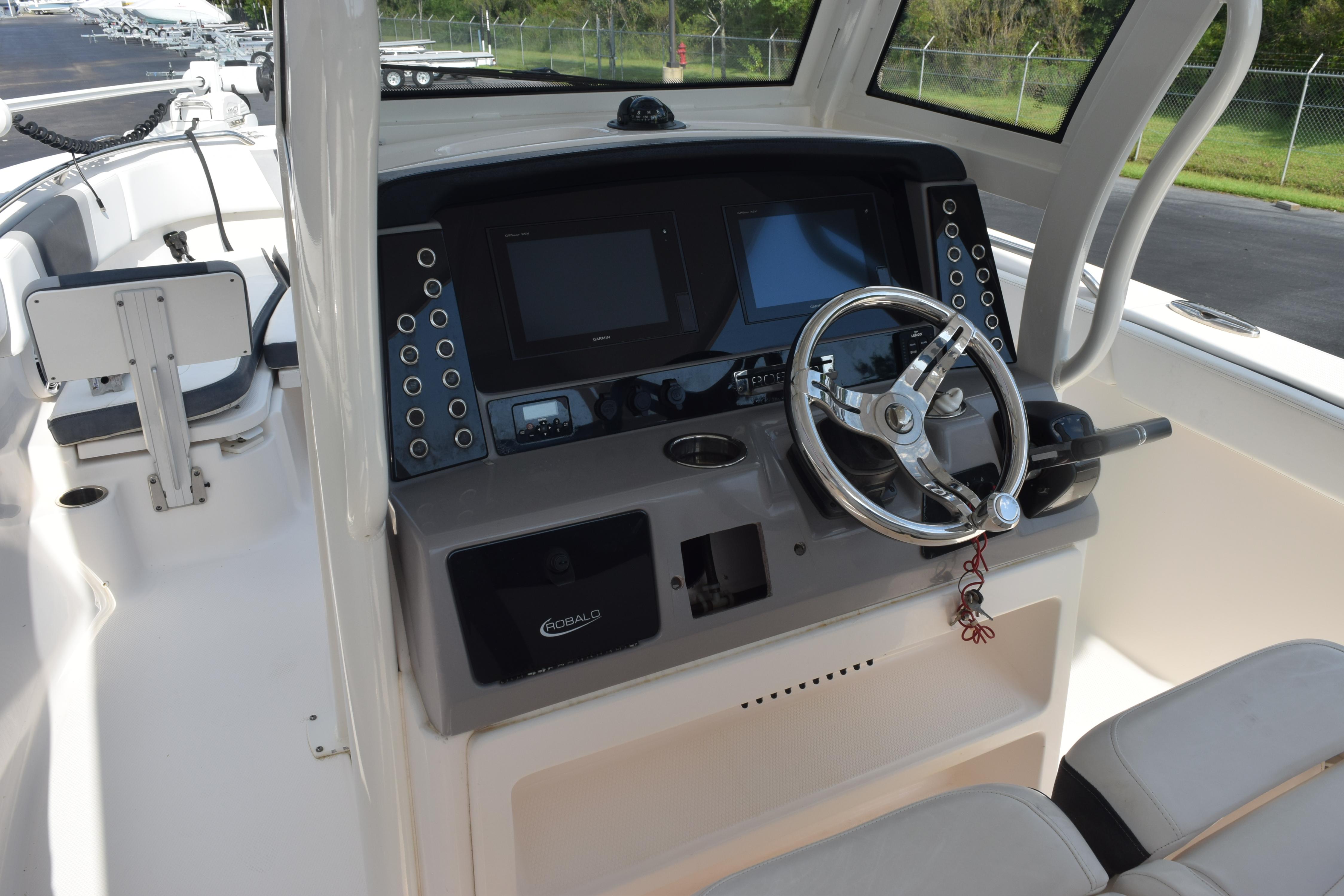 2019 Robalo R272 Center Console boat dashboard with steering wheel and control panel.