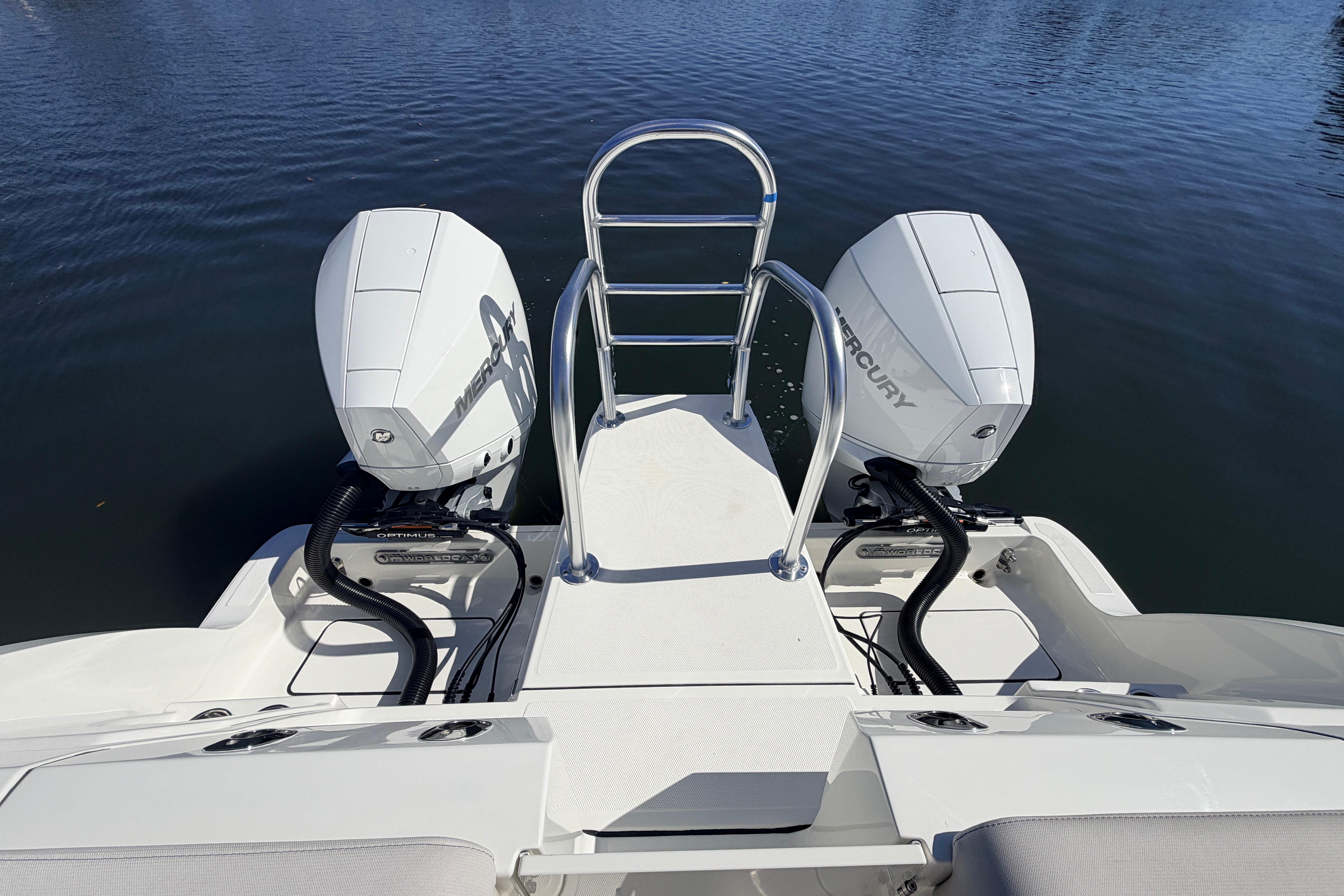 2026 World Cat 265 DC-X boat with dual Mercury outboard engines on calm water.