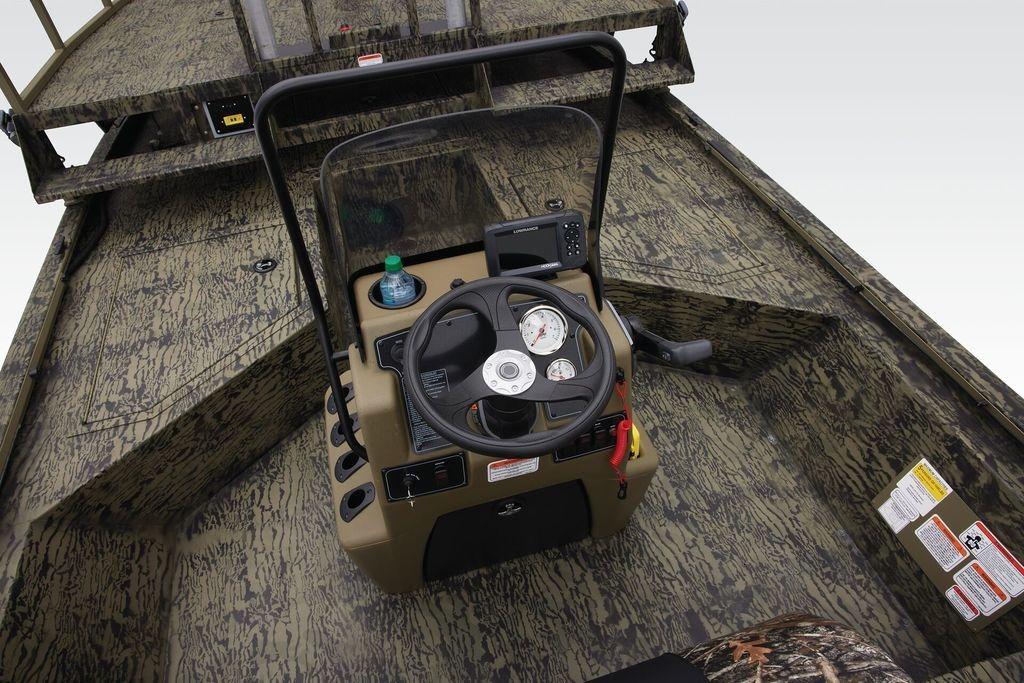 2026 Tracker GRIZZLY® 2072 CC Sportsman boat interior with camouflage design and steering console.
