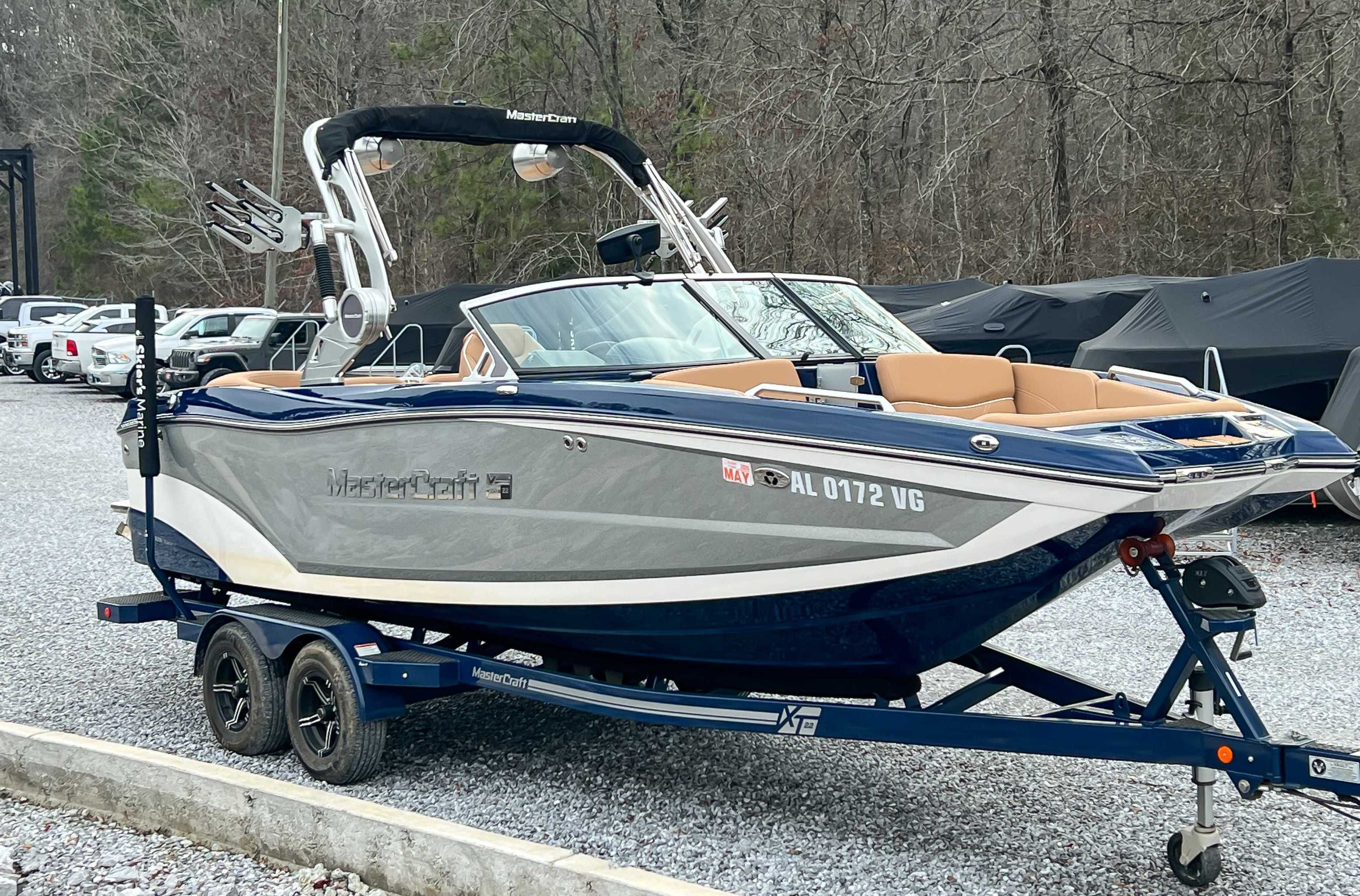 2021 MasterCraft XT22 boat parked on trailer outdoors.