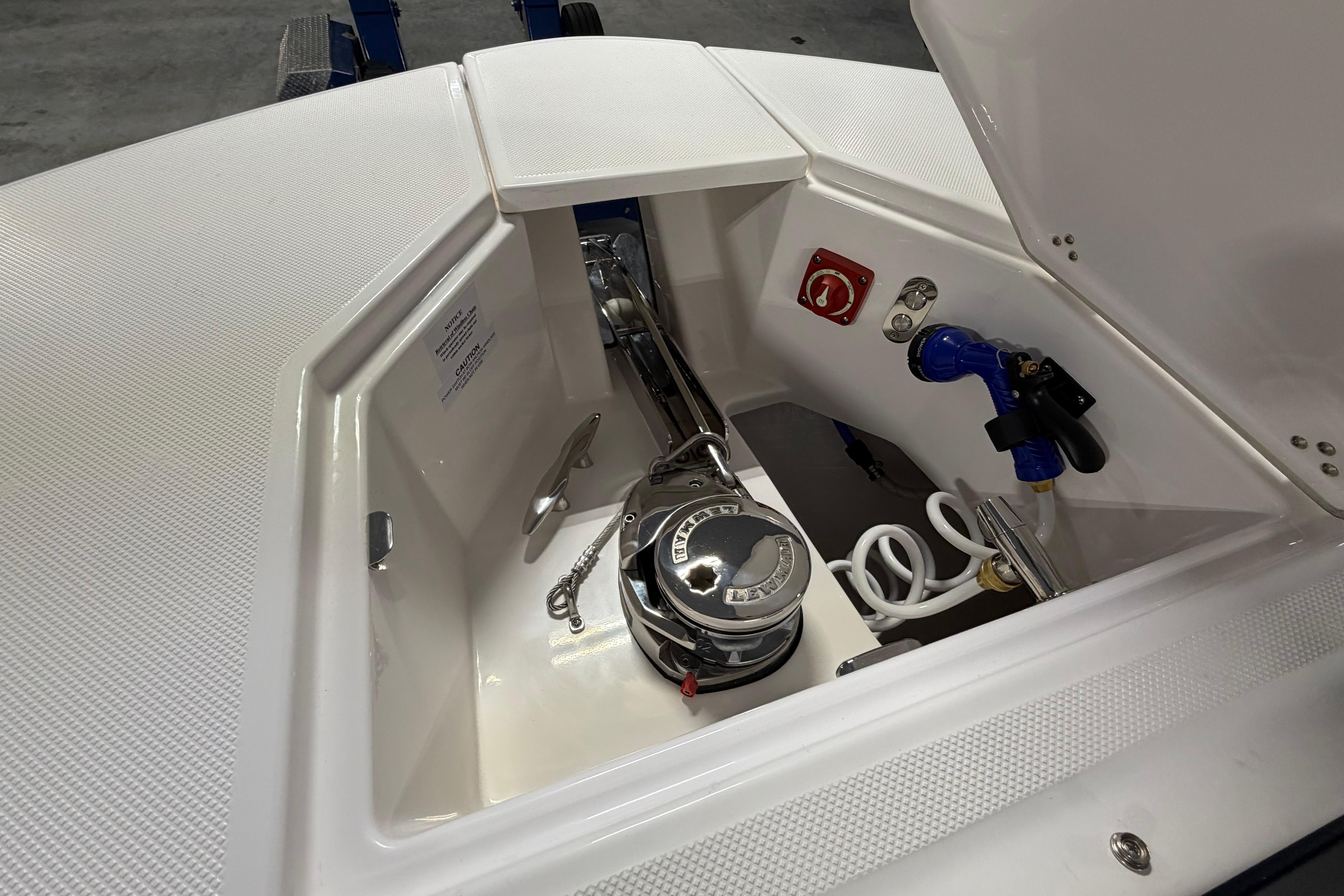 2027 Regal 38 Surf boat anchor compartment with winch and hose connections.