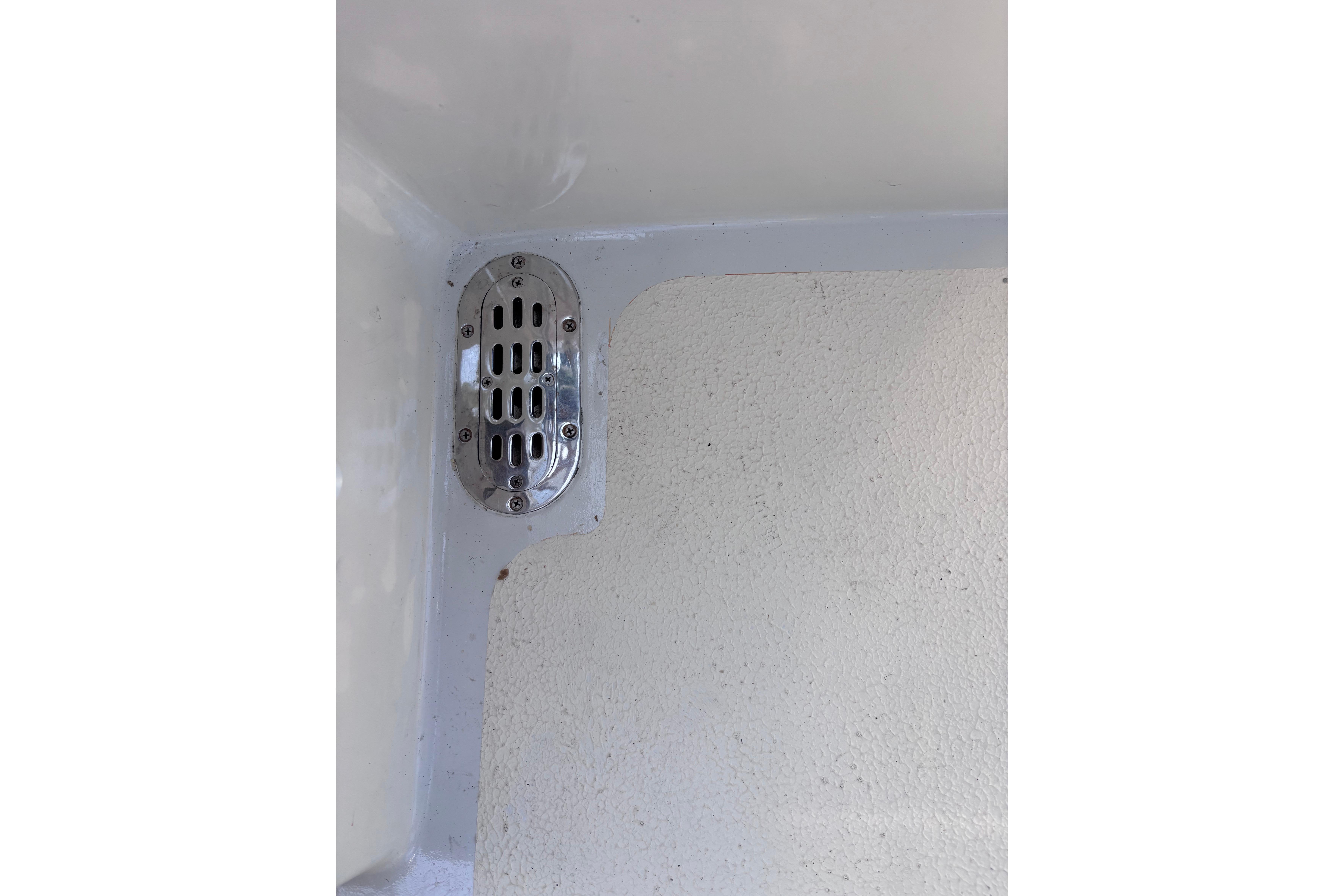 Chrome drain cover on 1978 Swift 33 boat interior.