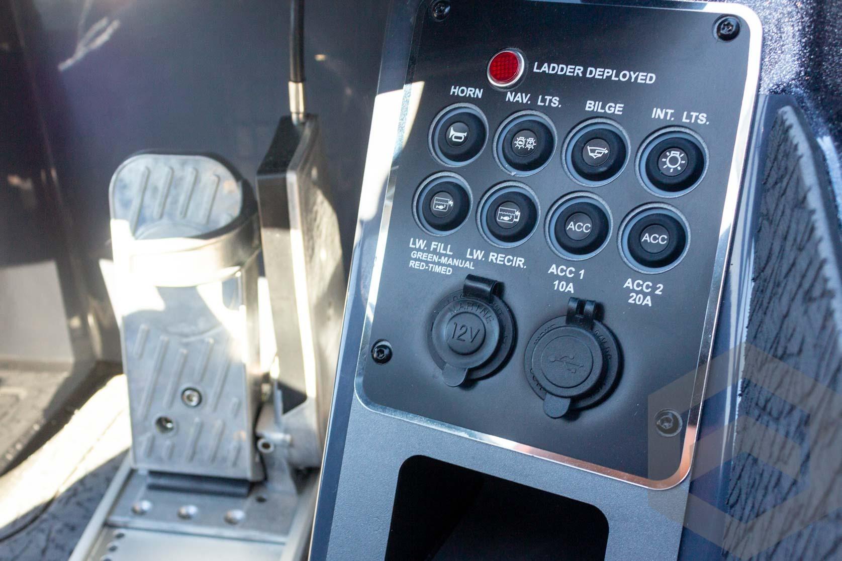 Control panel of 2026 Vexus VXs21 boat with various switches and foot pedal.