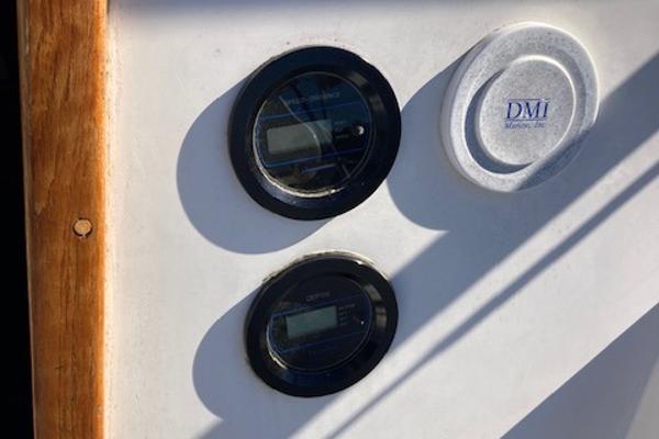 Control panel on a 1989 Catalina 30 sailboat with gauges and DMI logo.