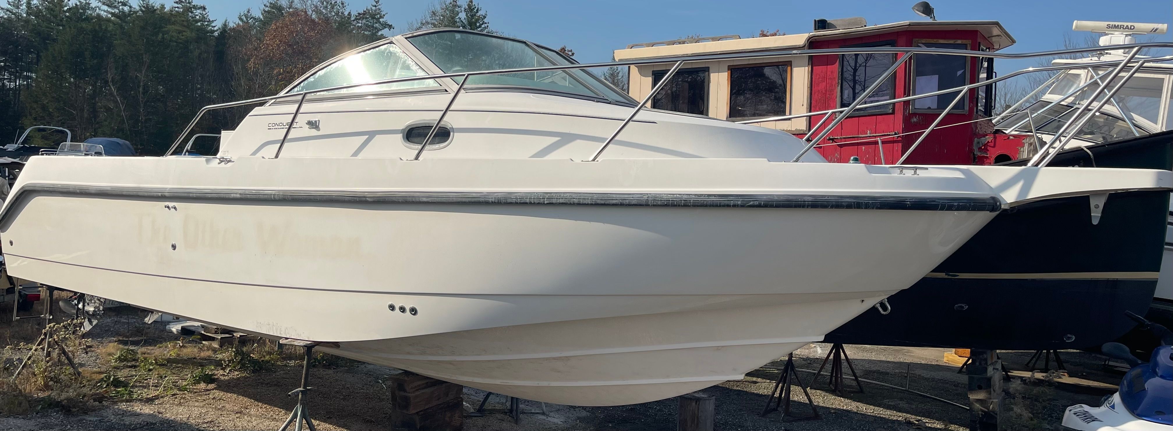 2001 Boston Whaler 26 Conquest boat on a dry dock.