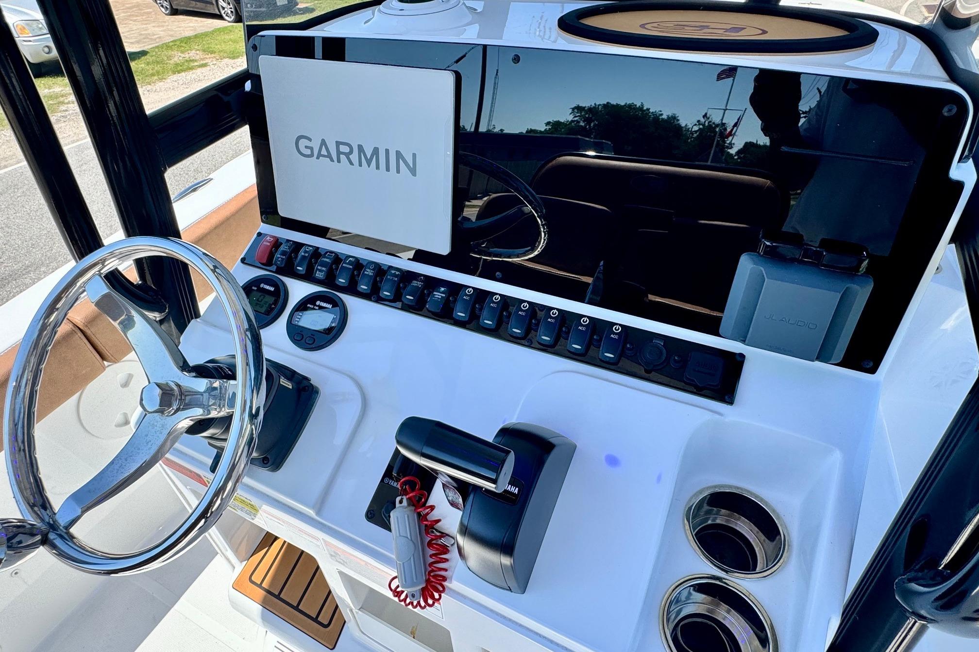2025 Sea Hunt Ultra 219 boat dashboard with Garmin navigation system and steering wheel.