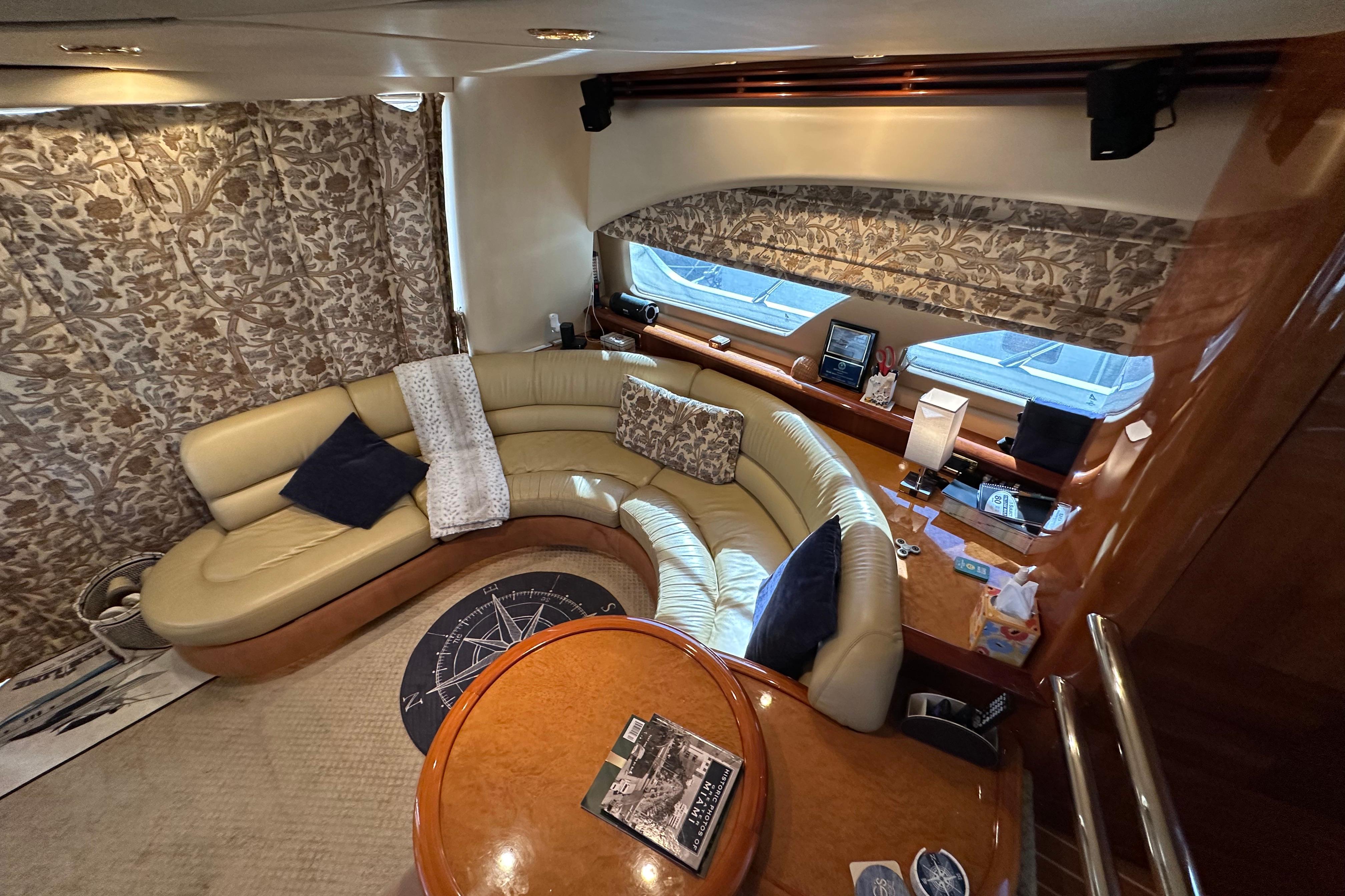 Luxurious interior of a 2004 Azimut 55E yacht with elegant seating and decor.