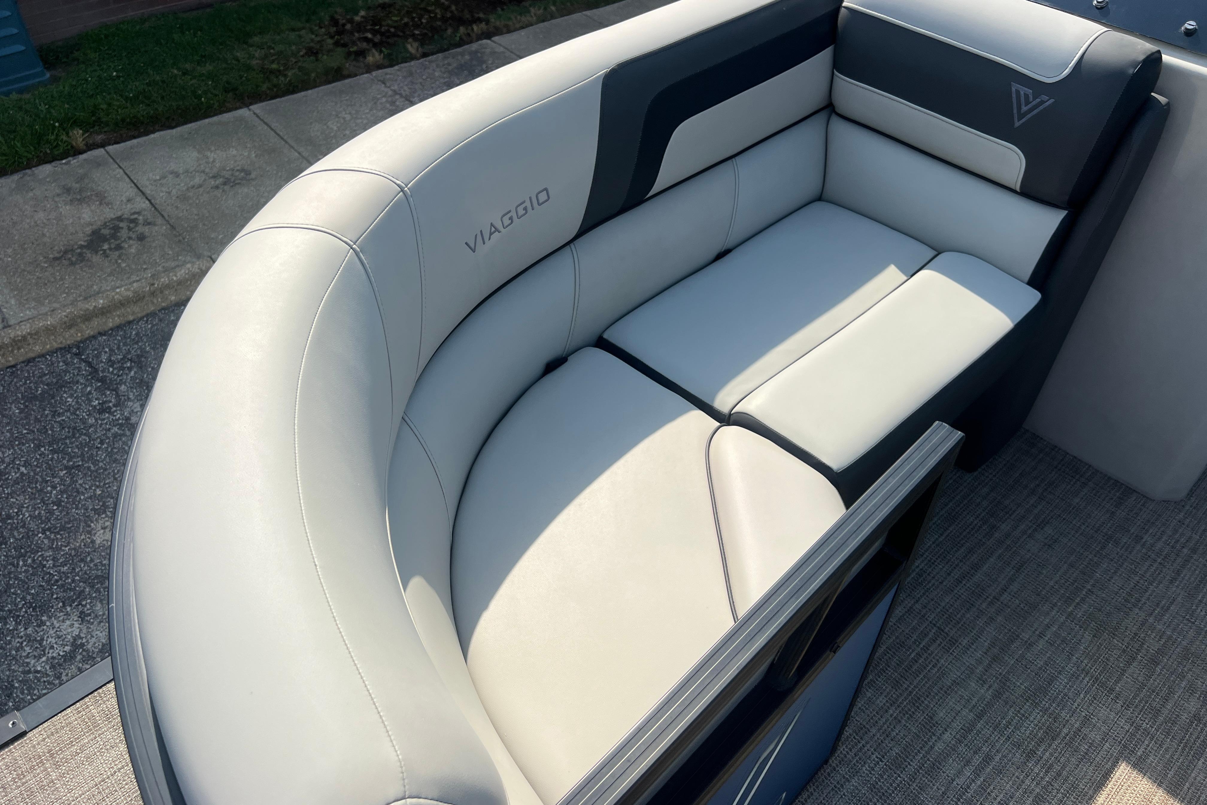 Luxurious seating on 2022 Viaggio Lago V-U 22 boat, featuring elegant white and gray upholstery.