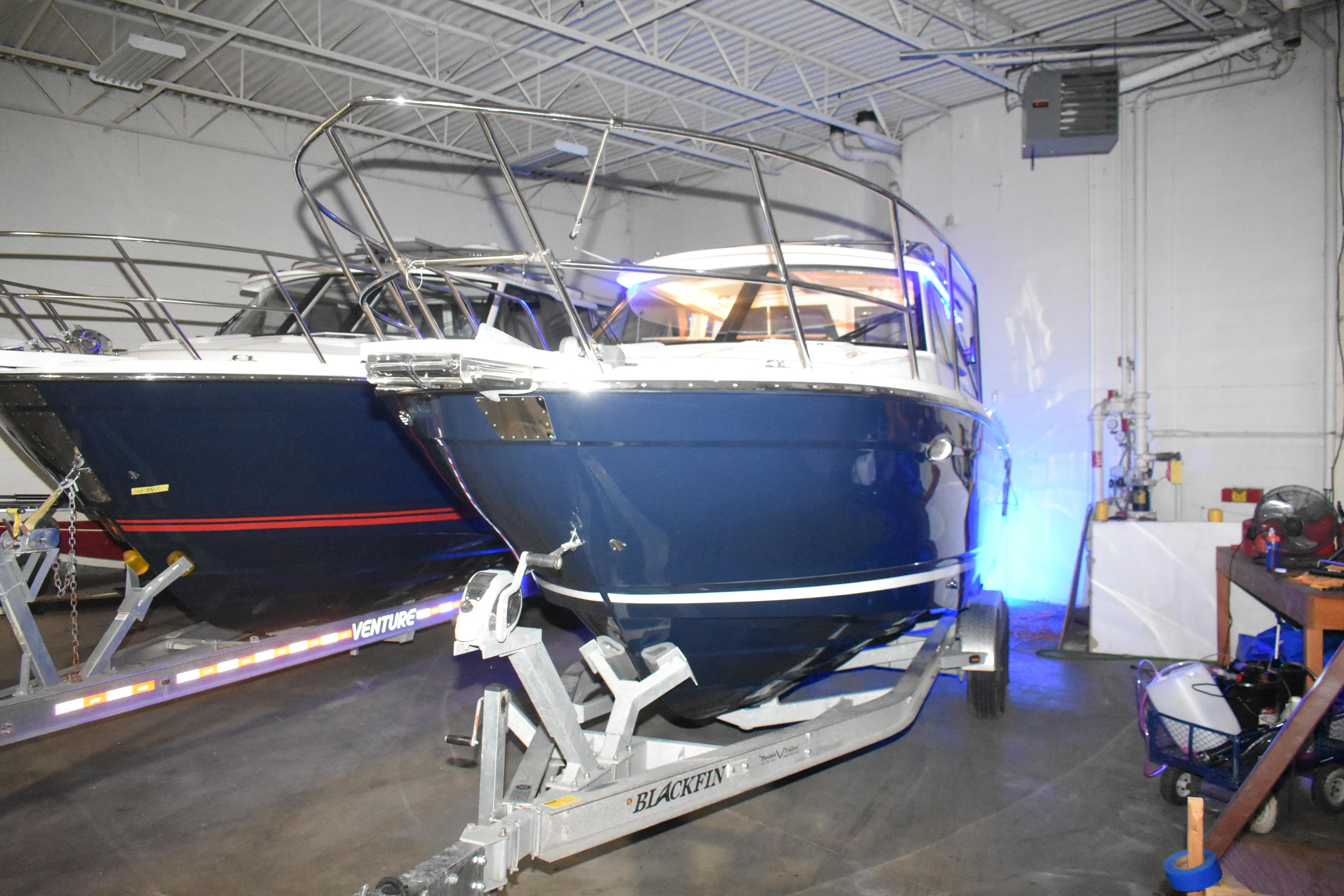 2026 Cutwater C-248 Coupe boat in a garage on a trailer.