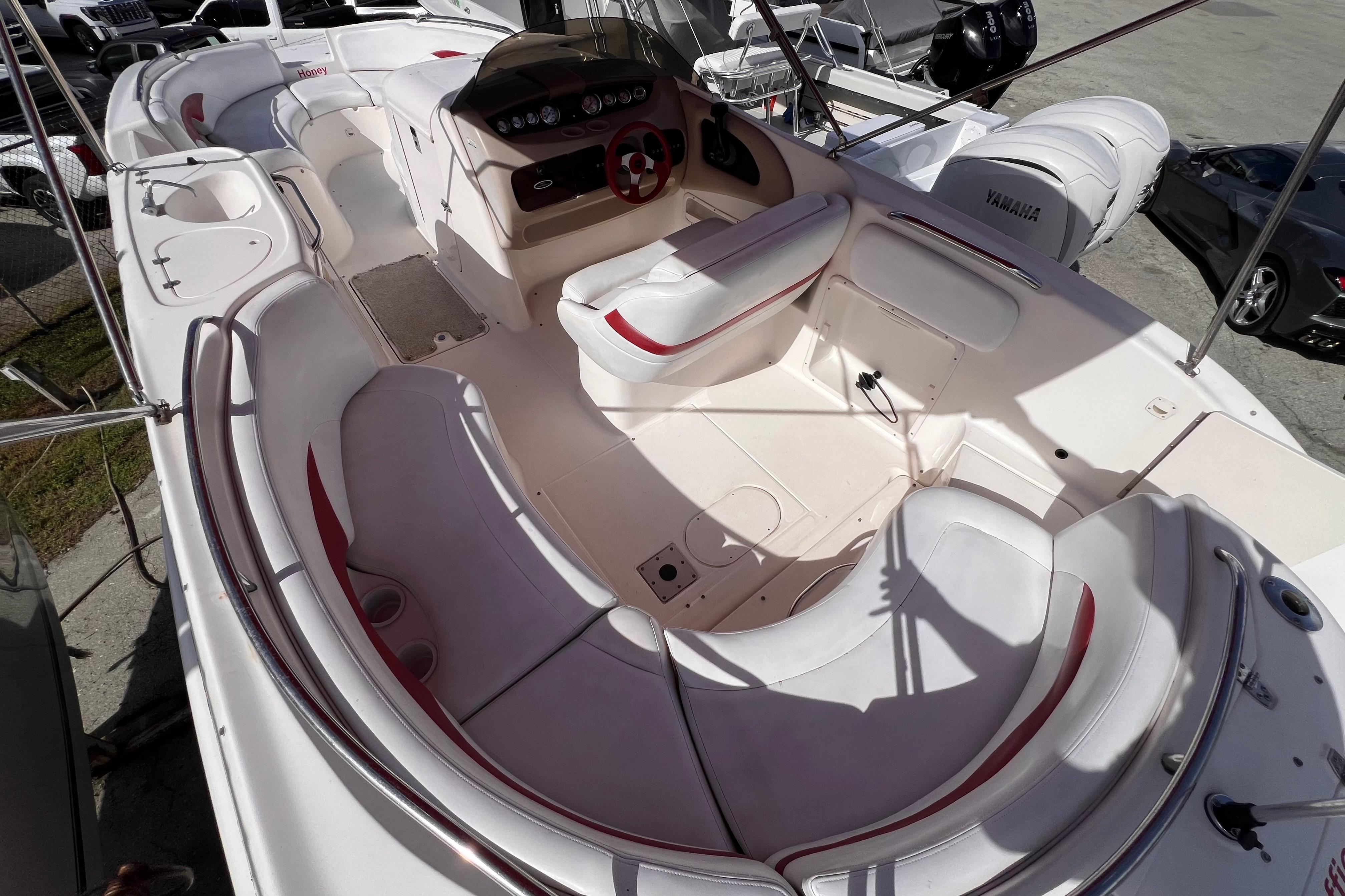 2002 Chaparral 232 Sunesta boat interior with white seating and control panel.