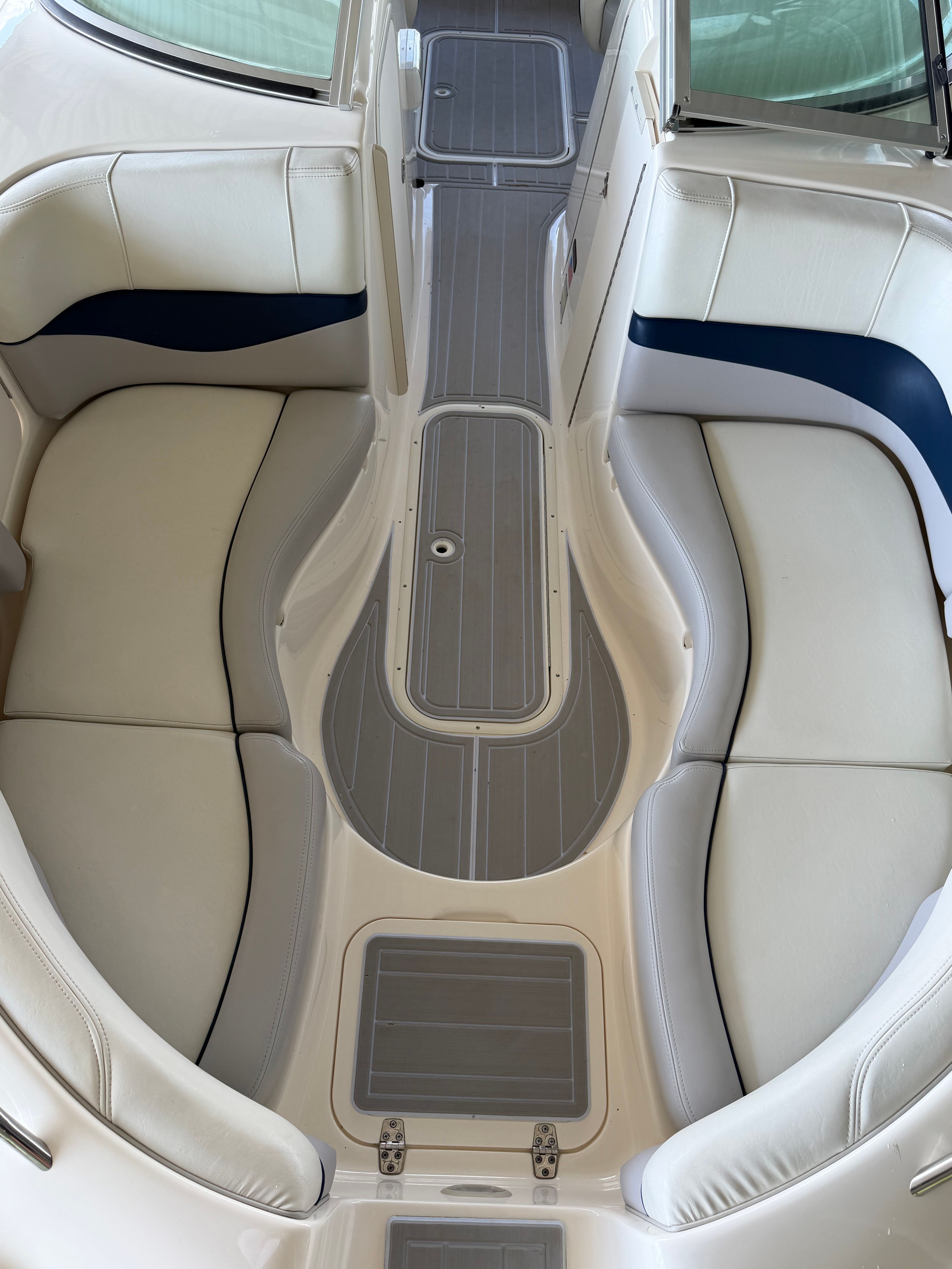 Interior of a 2010 Bryant 255 boat with beige seating.