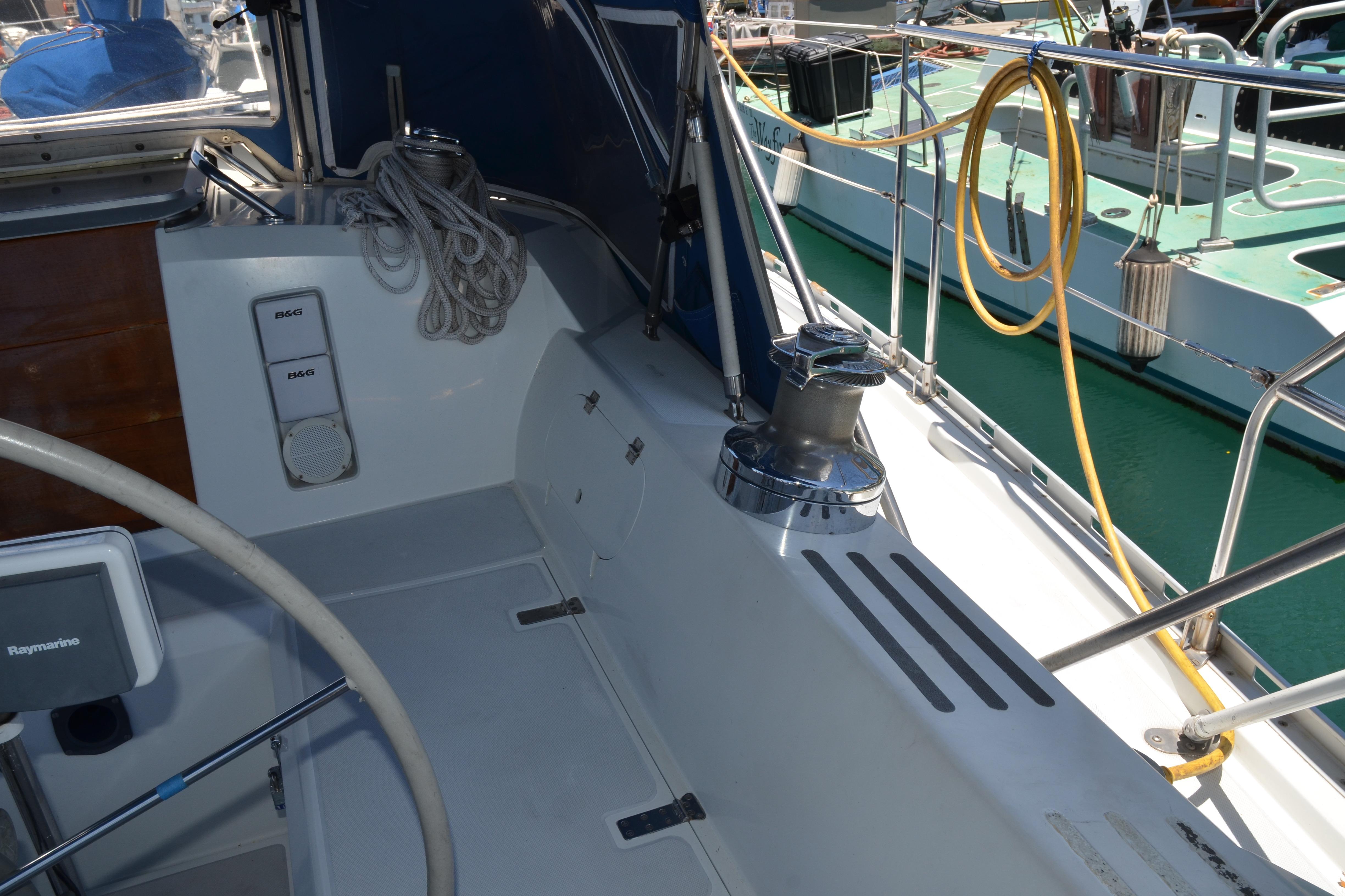 Cockpit of 1987 Norseman 400 sailboat with steering wheel and winch.