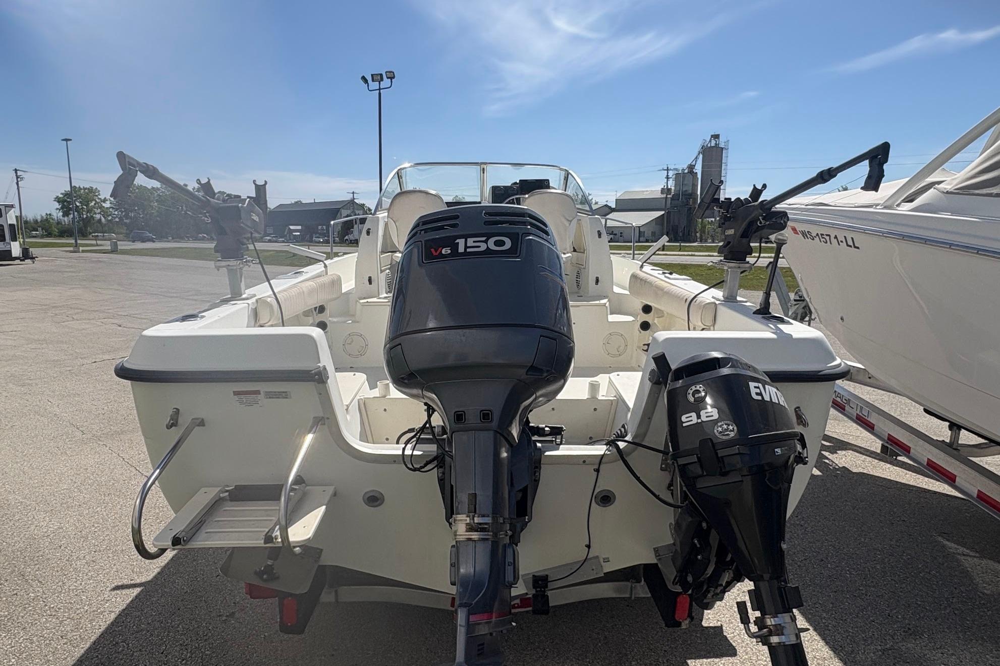2002 Hydra-Sports 212 WA boat with dual outboard motors in a marina setting.