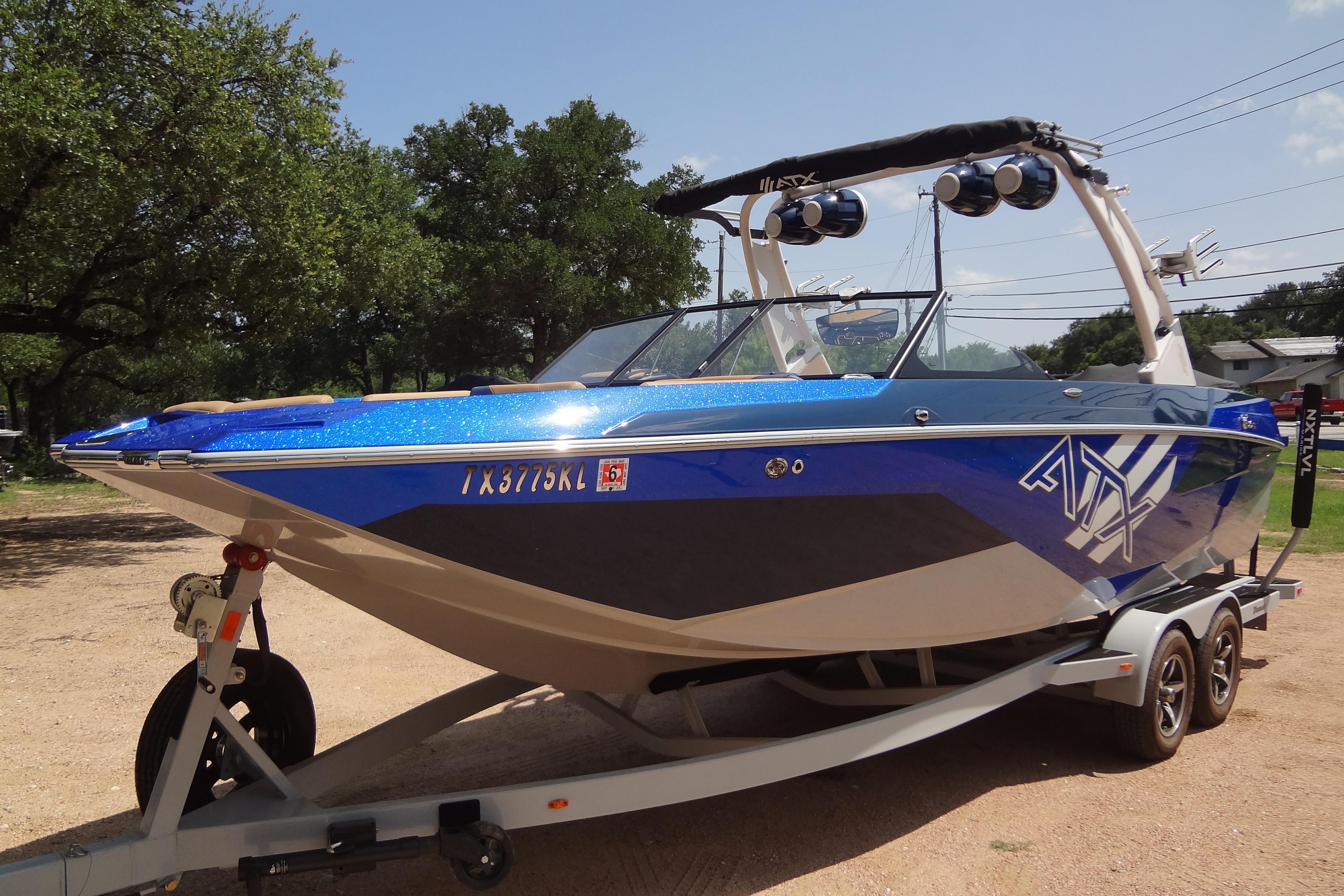 2022 ATX Surf Boats 24 Type-S in blue on trailer, parked outdoors.