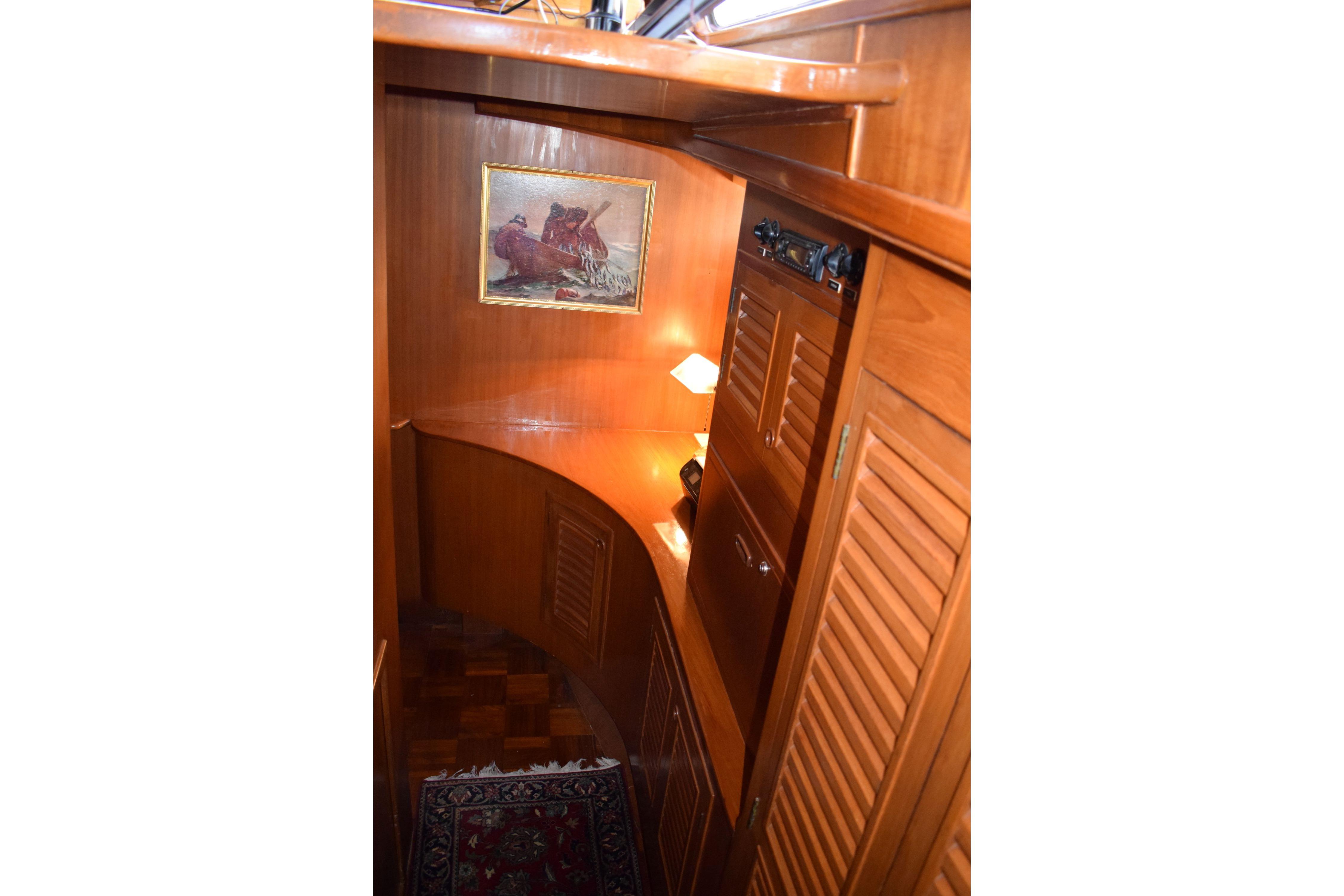 Interior of 1980 Cheoy Lee 52 Motorsailer with wooden cabinetry and nautical decor.