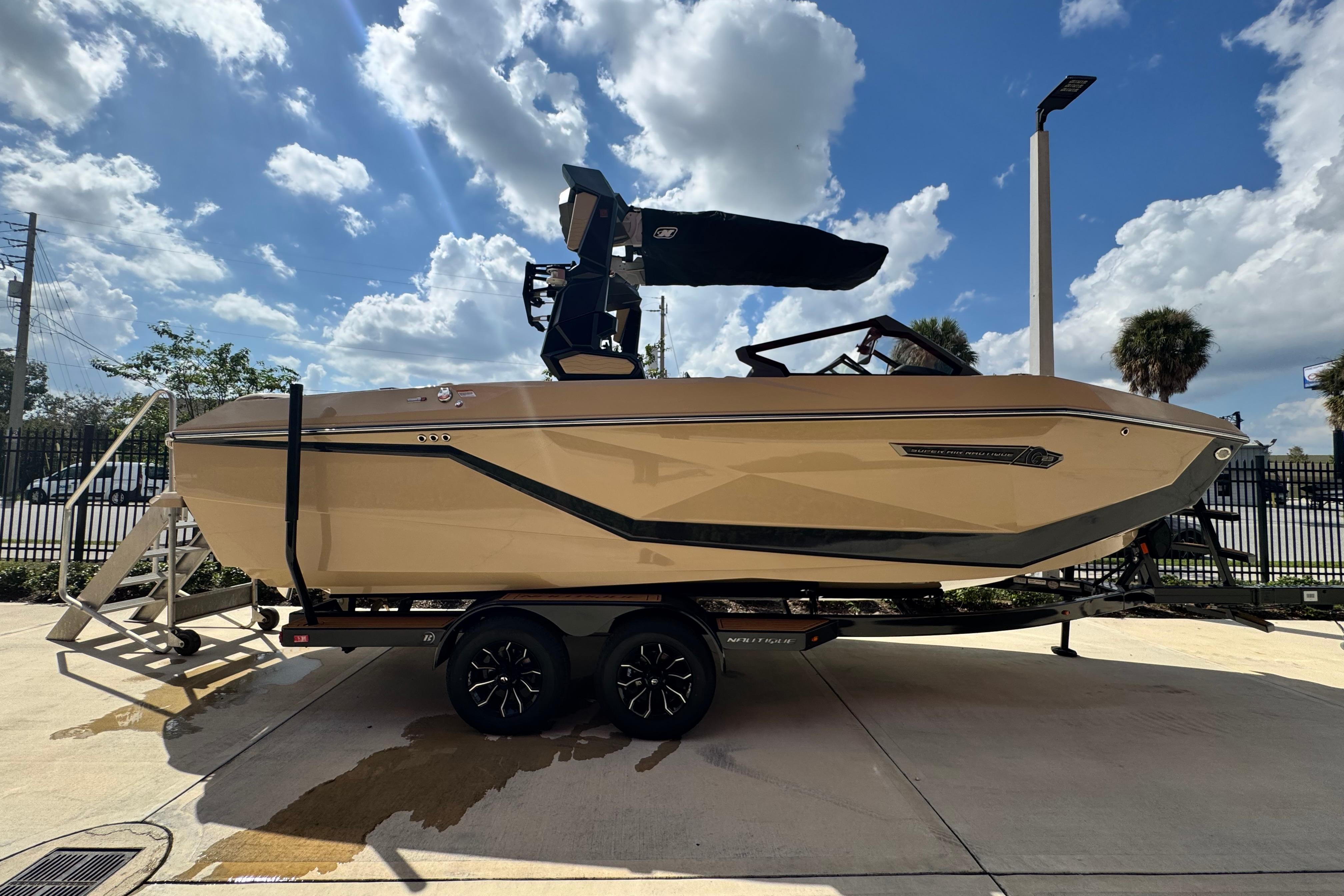 2026 Nautique Super Air Nautique G23 Paragon boat on trailer under a blue sky.
