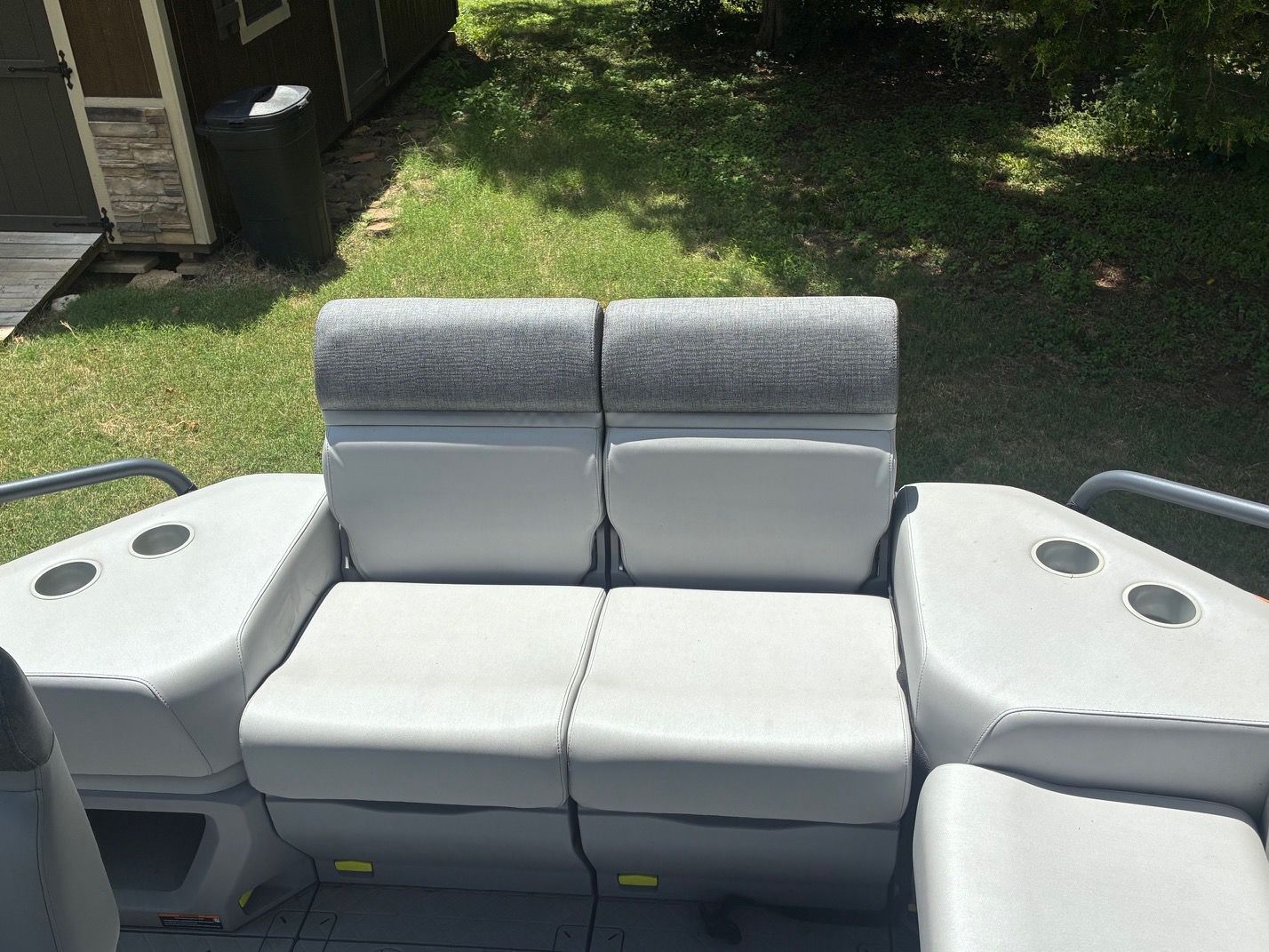 The 2023 Sea-Doo Switch Sport 18 features a gray bench seat with cup holders.