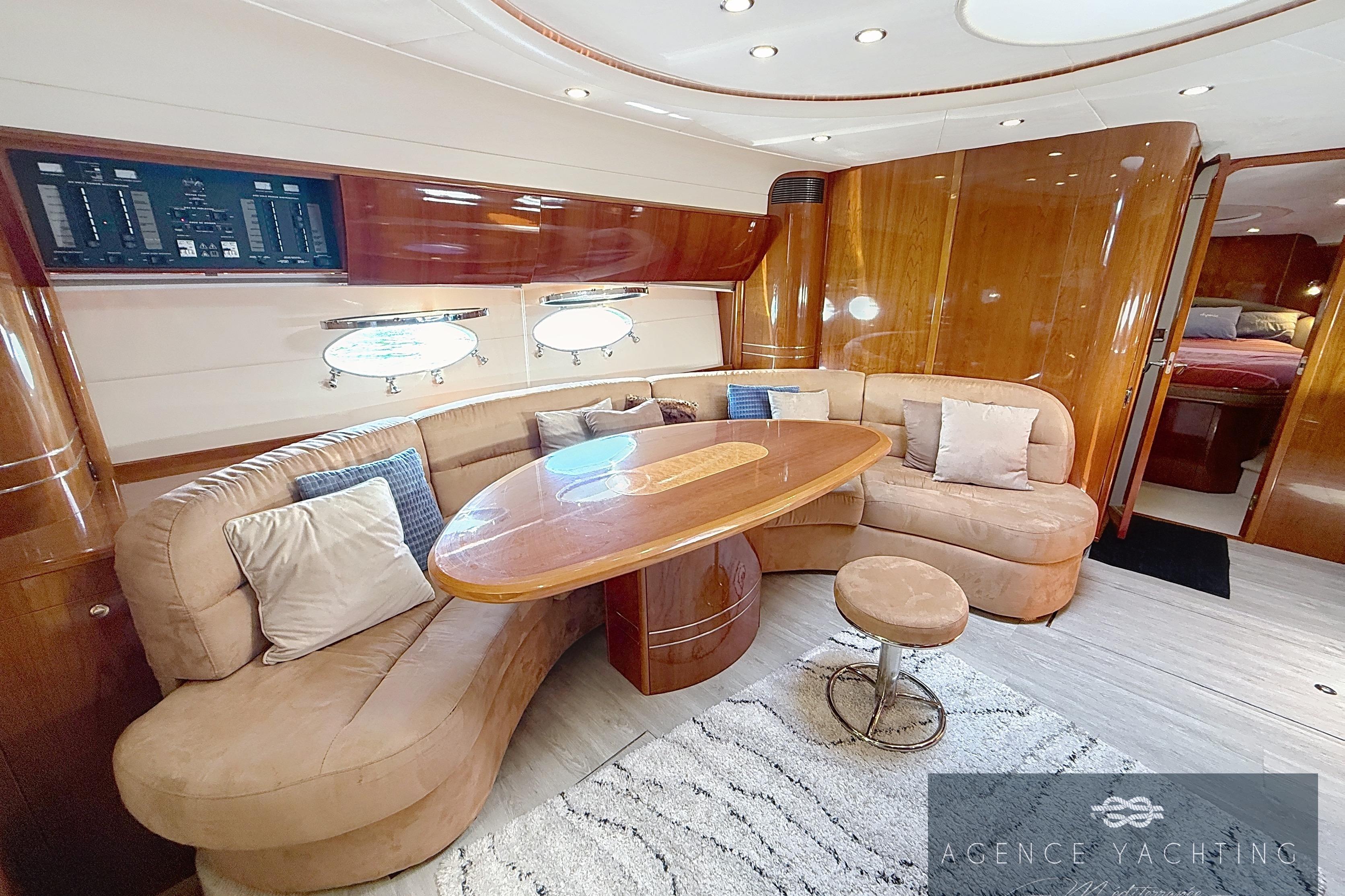 Luxurious 2004 Princess V58 yacht interior with plush seating and elegant wooden finishes.