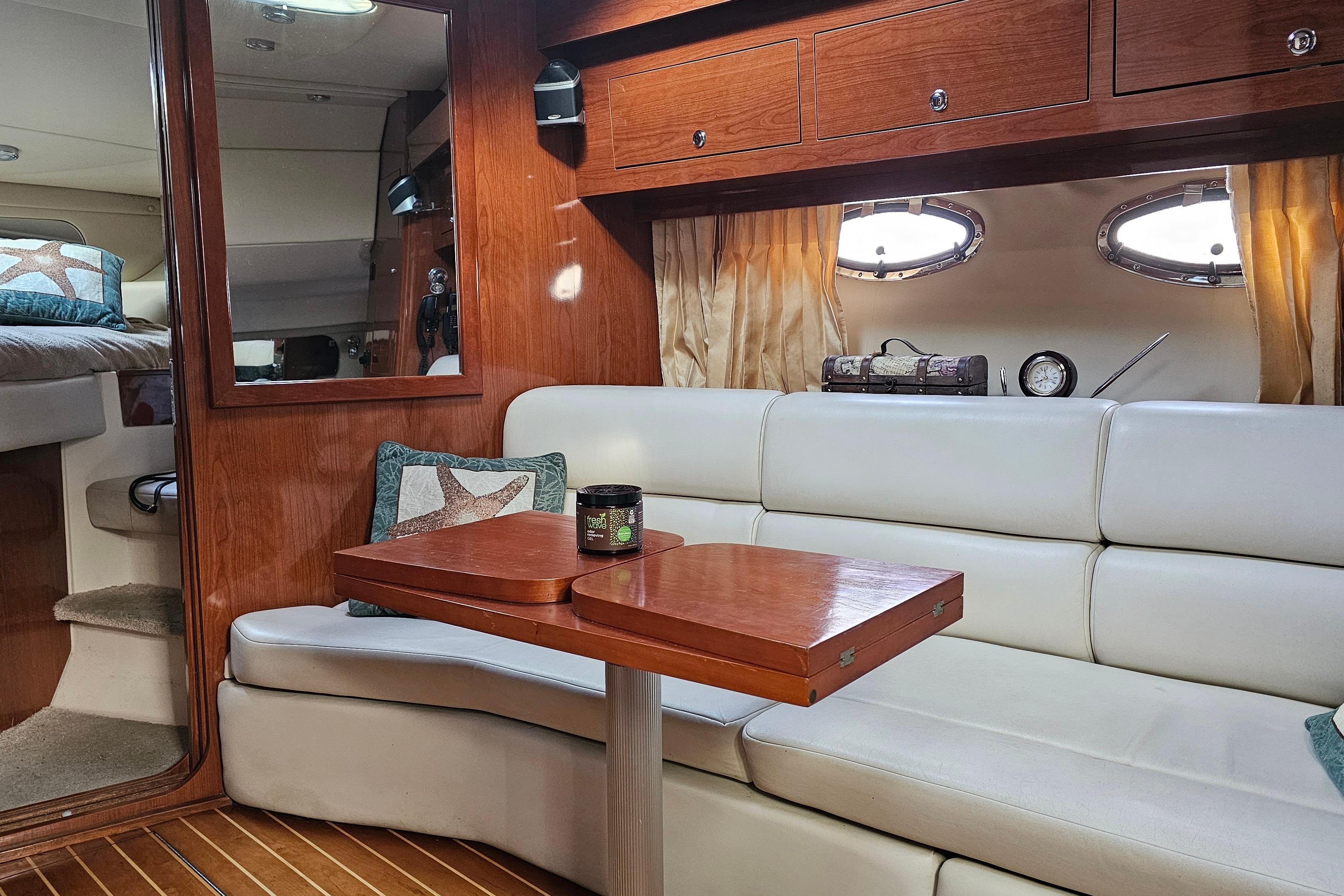 Interior of 2006 Regal Commodore 3560 yacht with elegant seating and wooden accents.