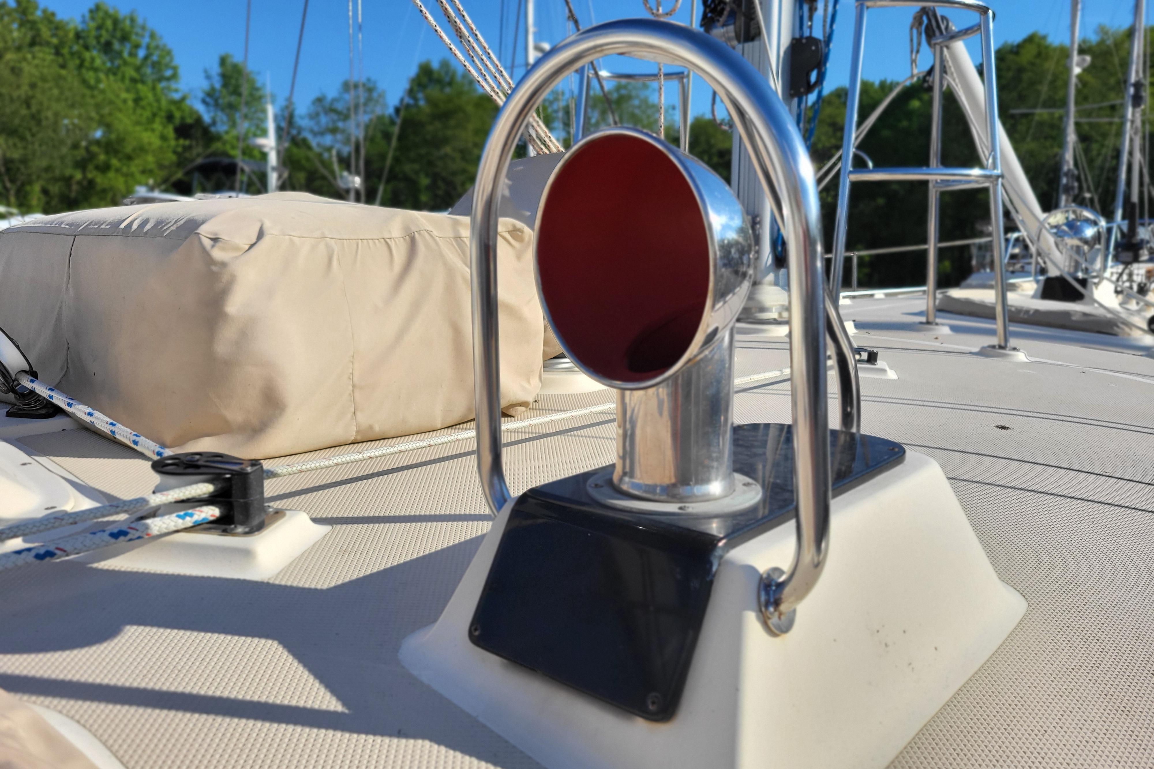 Deck view of a 2000 Island Packet 420 sailboat, featuring a chrome vent and rigging.