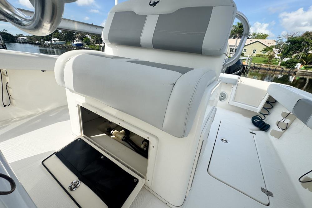 2018 Mako 284 Center Console boat interior with open storage compartment and seating.