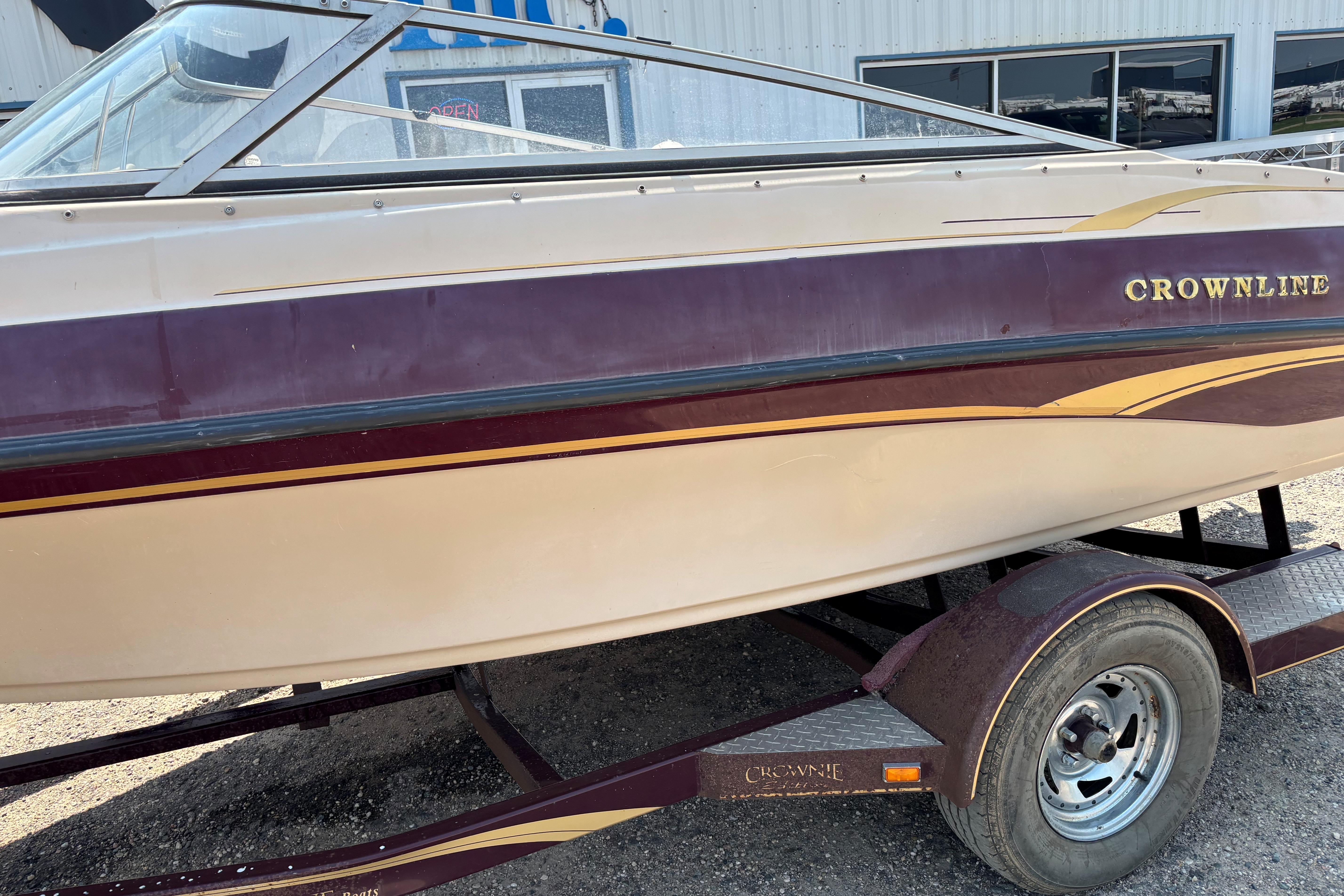 2001 Crownline 18' boat on trailer, maroon and cream color scheme.