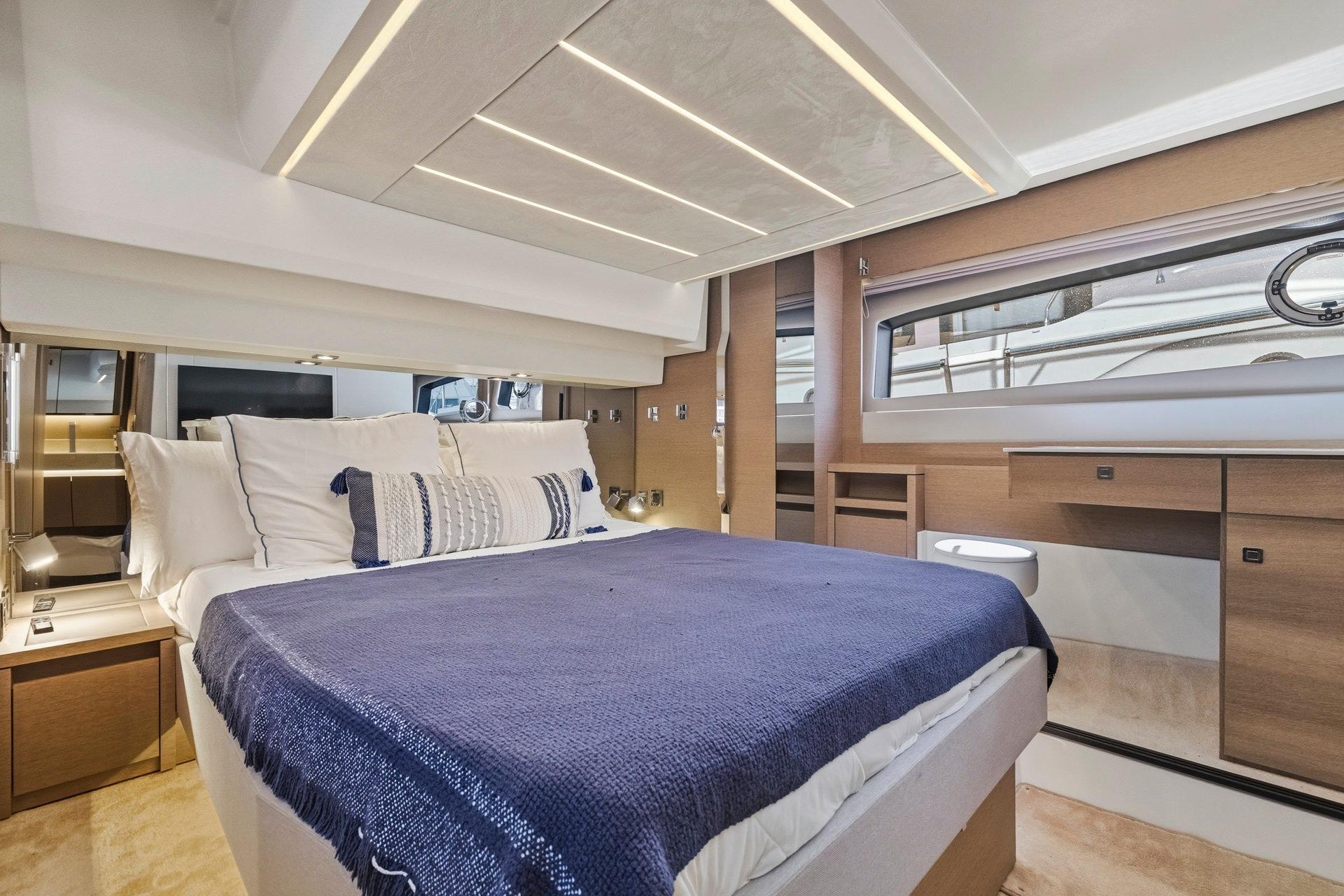 Luxurious 2022 Prestige 520 yacht bedroom with modern design and elegant furnishings.