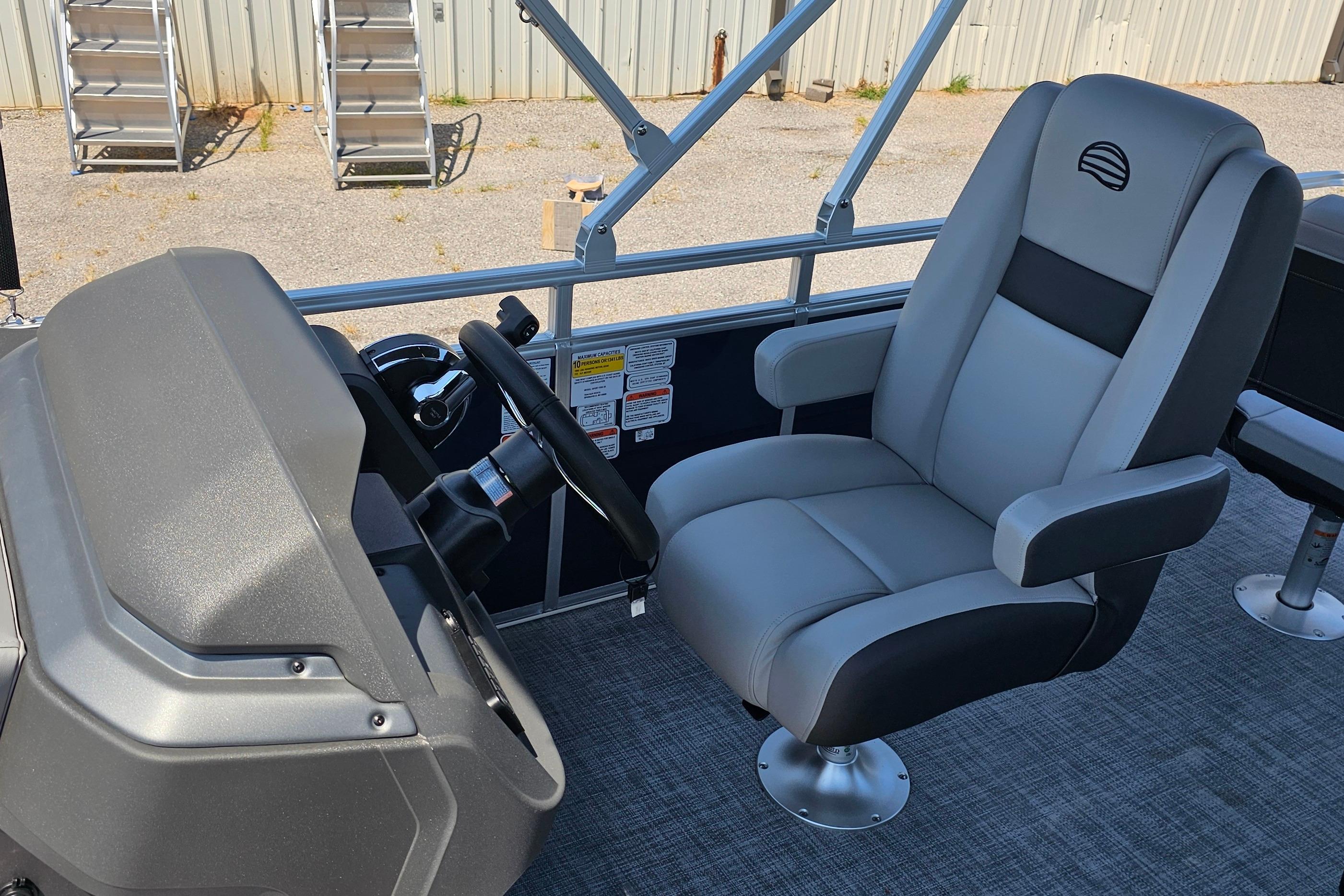 2026 Sun Tracker SportFish 20 DLX boat interior with captain's chair and steering console.