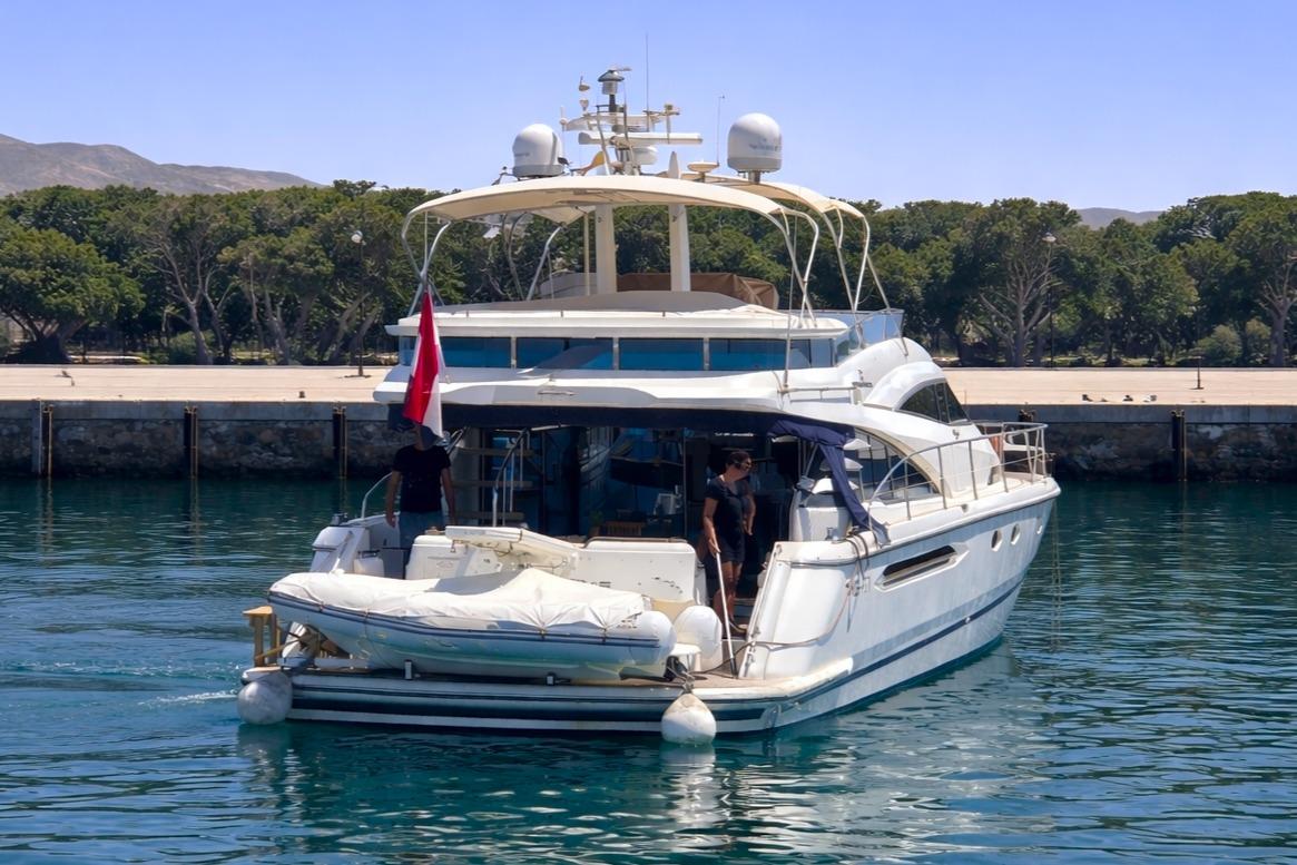 2001 Fairline Squadron 58 yacht docked in a serene marina setting.