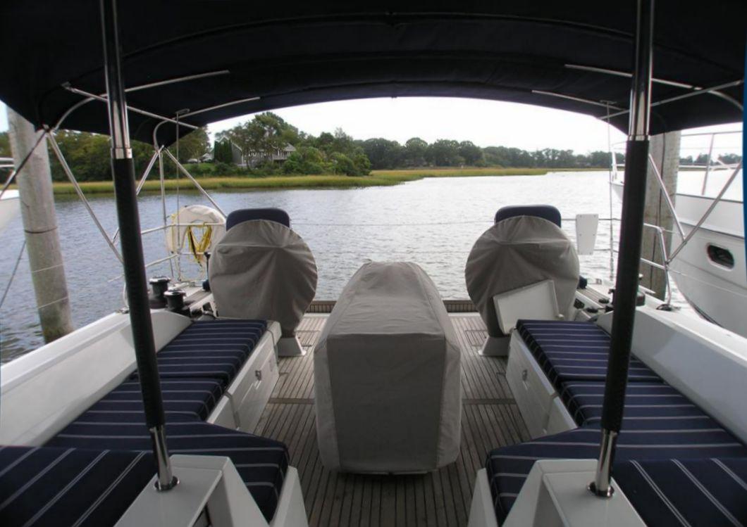 2019 Beneteau 51.1 yacht cockpit with covered seating and scenic water view.