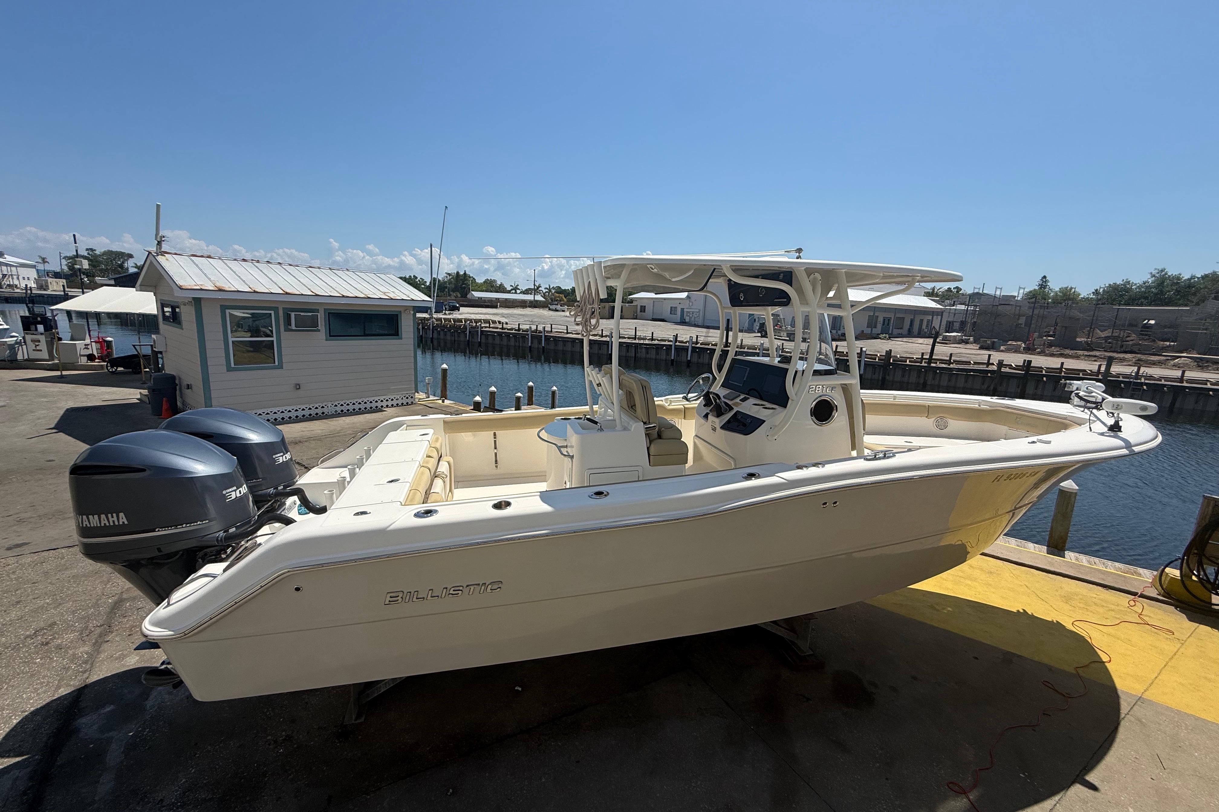 2019 Key West Billistic 281 Center Console boat docked with twin Yamaha engines.