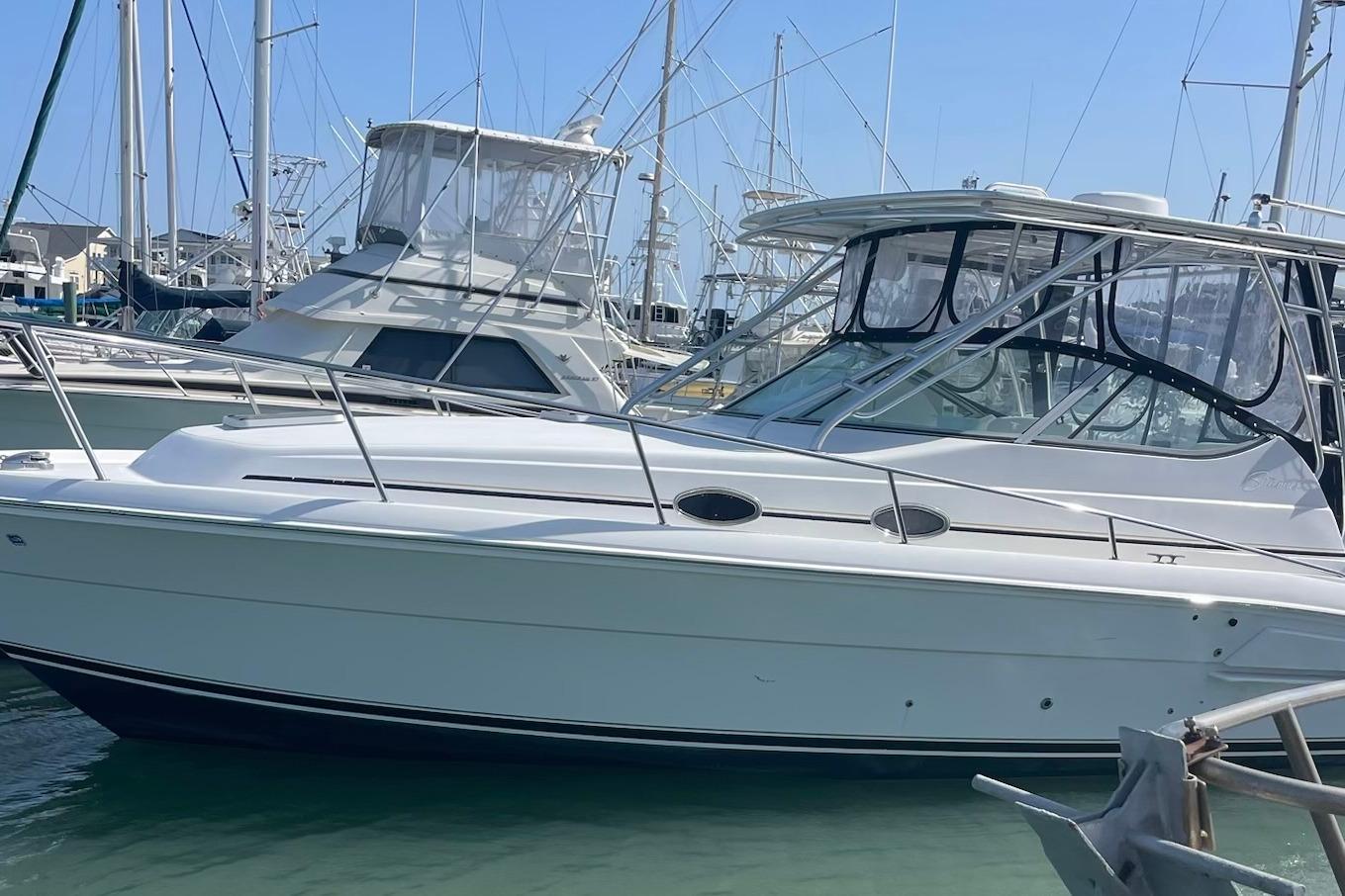 2008 Stamas 370 Express boat docked in a marina under clear blue skies.