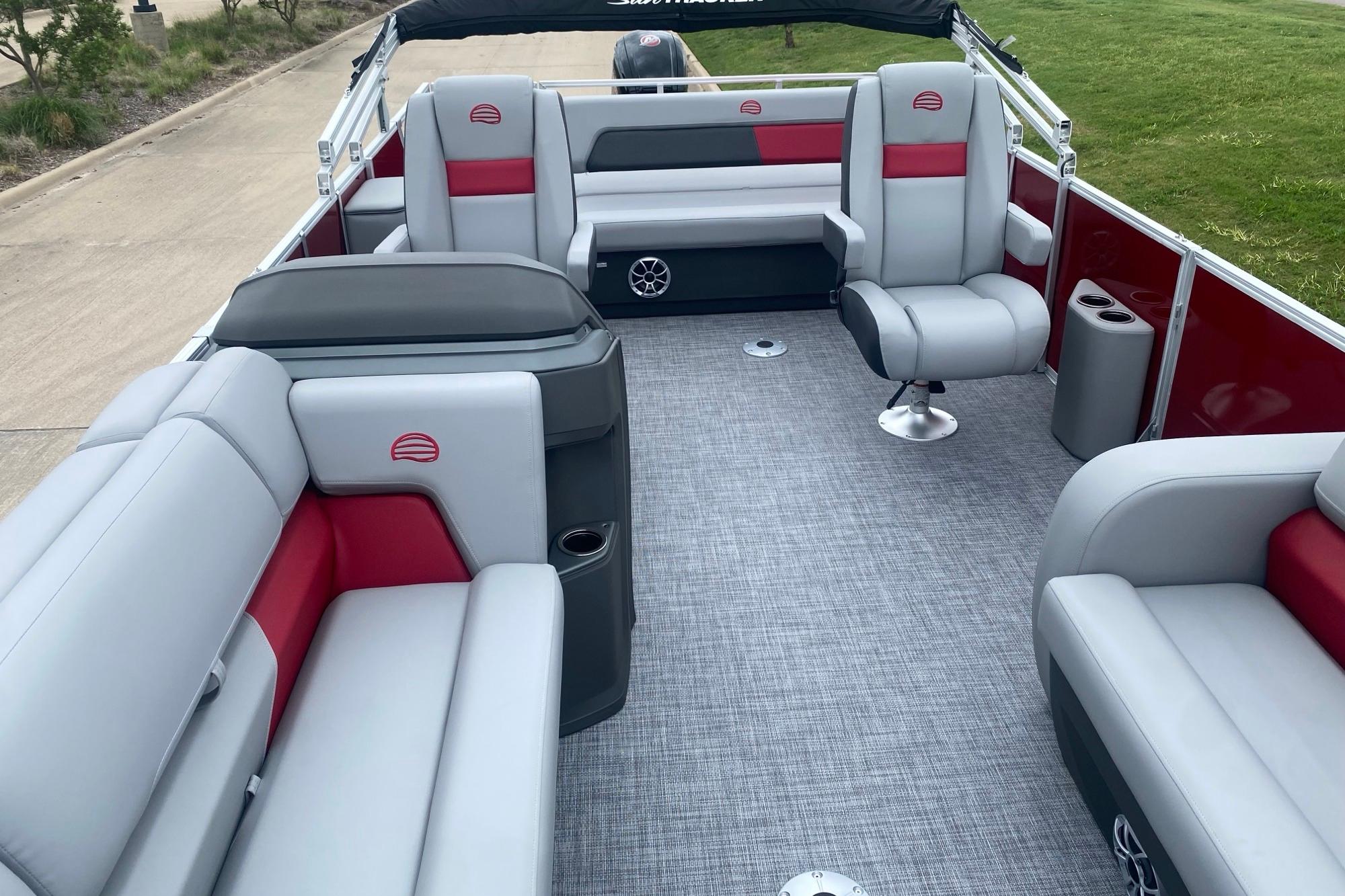 2026 Sun Tracker Party Barge 22 RF DLX interior with gray and red seating.