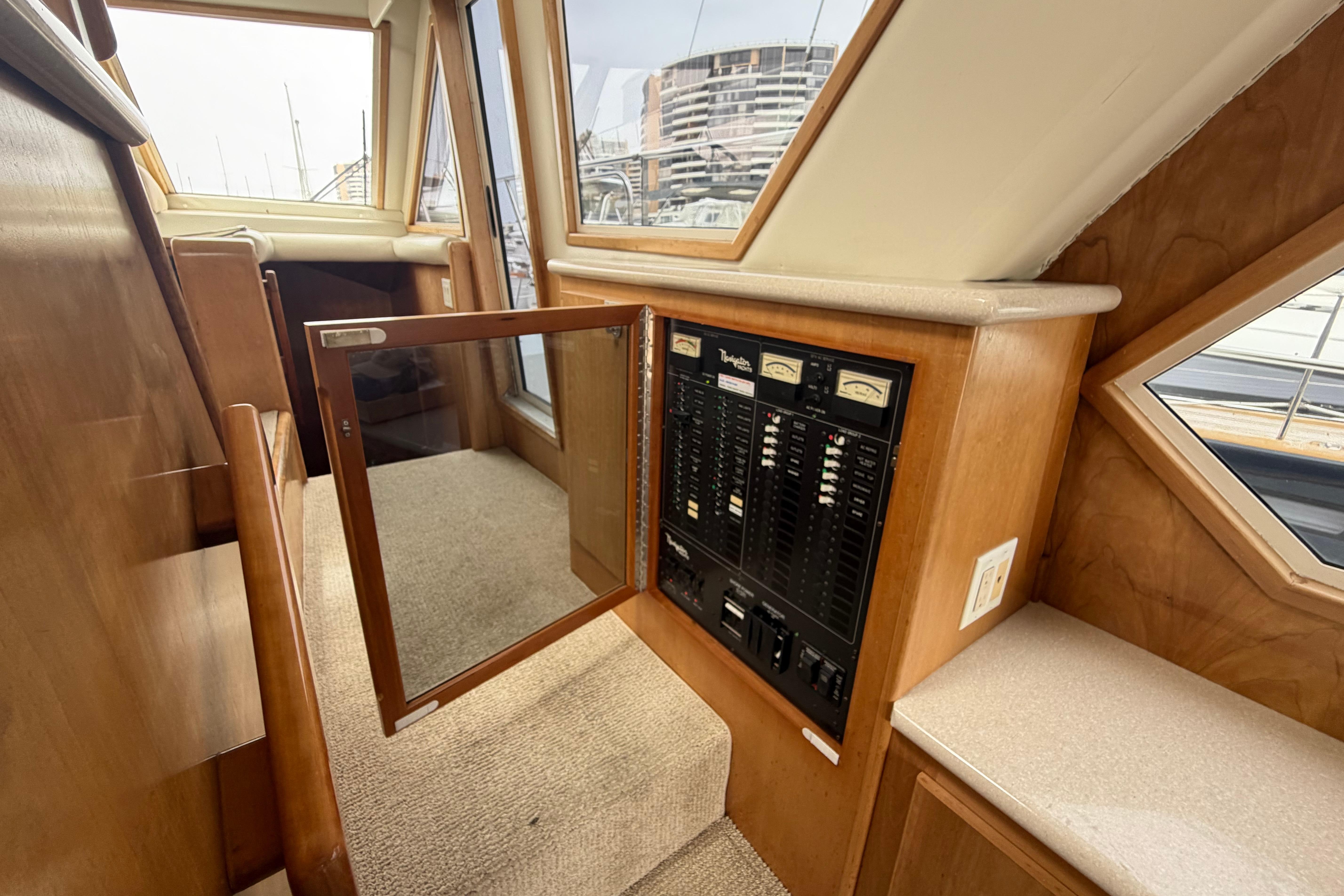 Interior view of a 2005 Navigator 53 Pilot House yacht with open control panel.