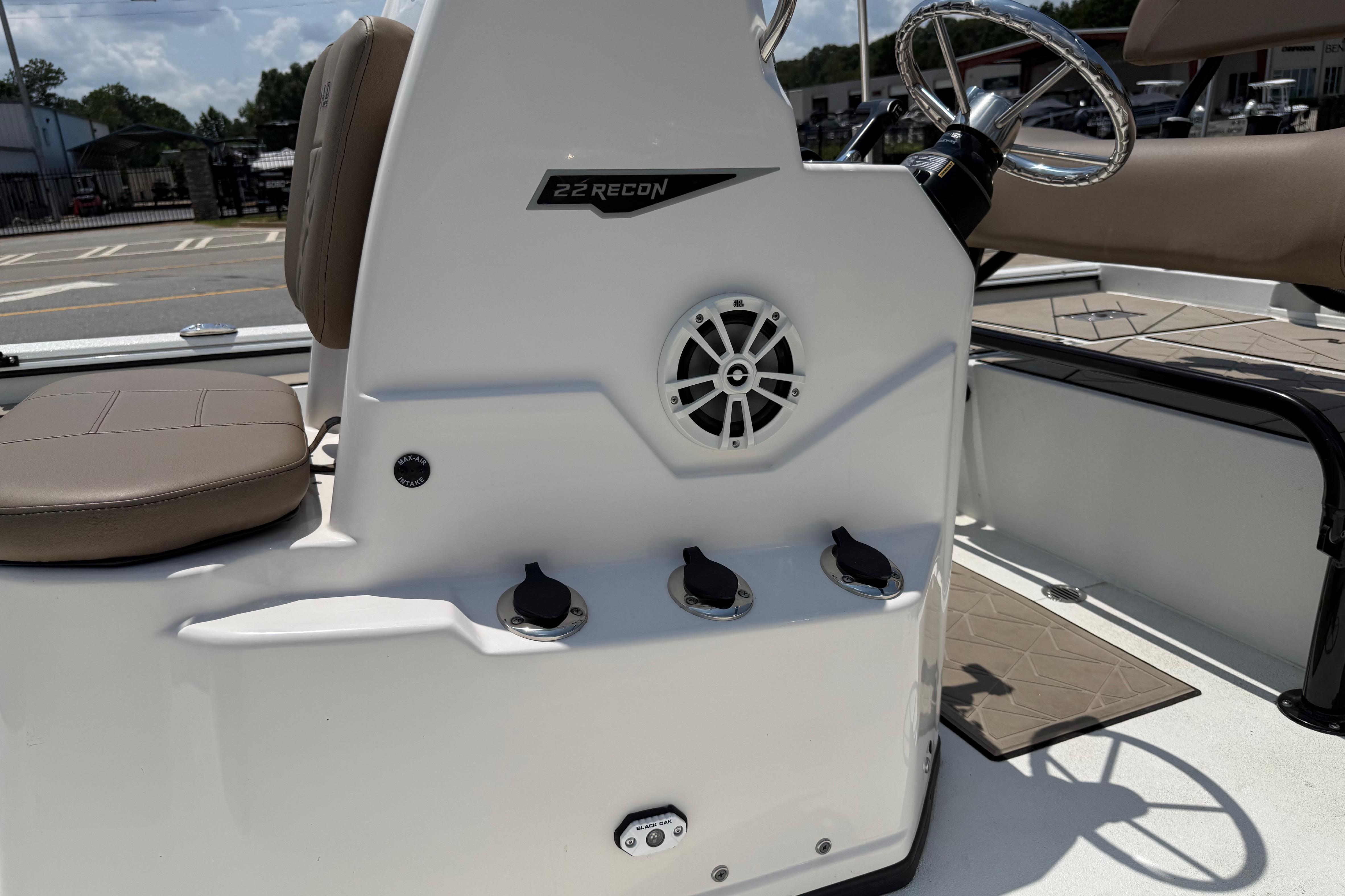 Avid 22 Recon 2025 boat interior with steering wheel and seating.