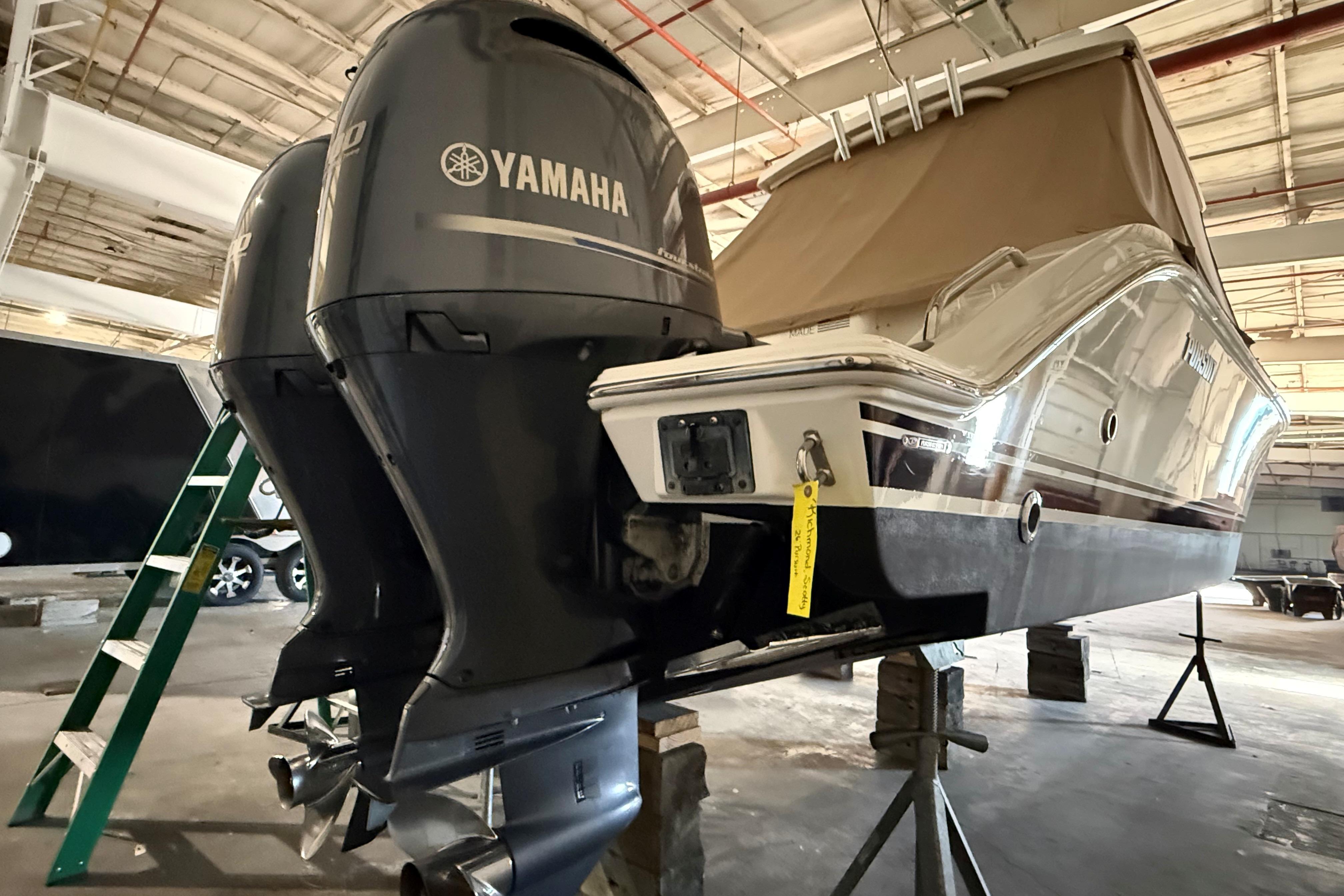 2021 Pursuit S 268 Sport boat with Yamaha outboard engines in a warehouse.