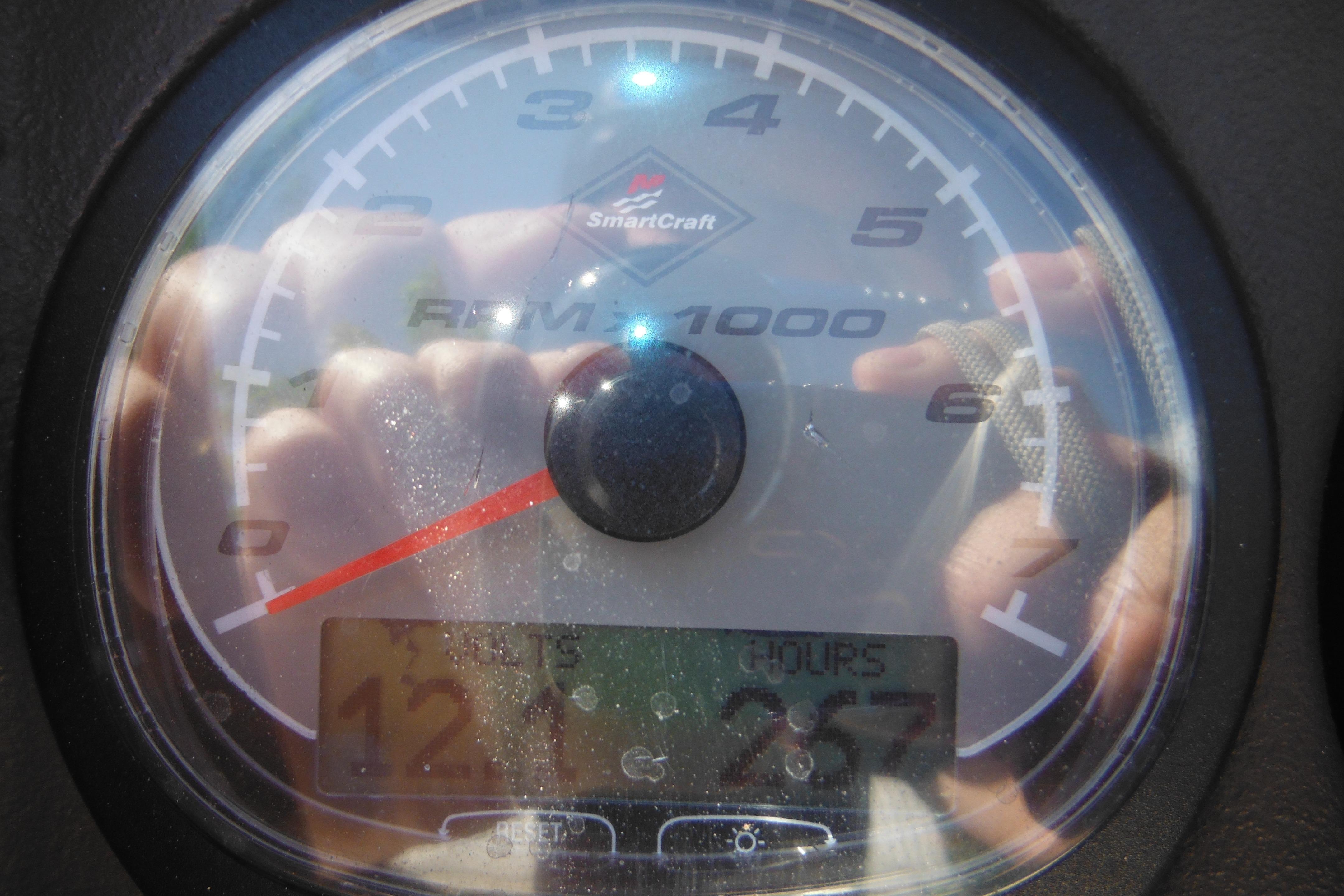 Close-up of a 2009 Boston Whaler 200 Dauntless tachometer displaying RPM and hours.